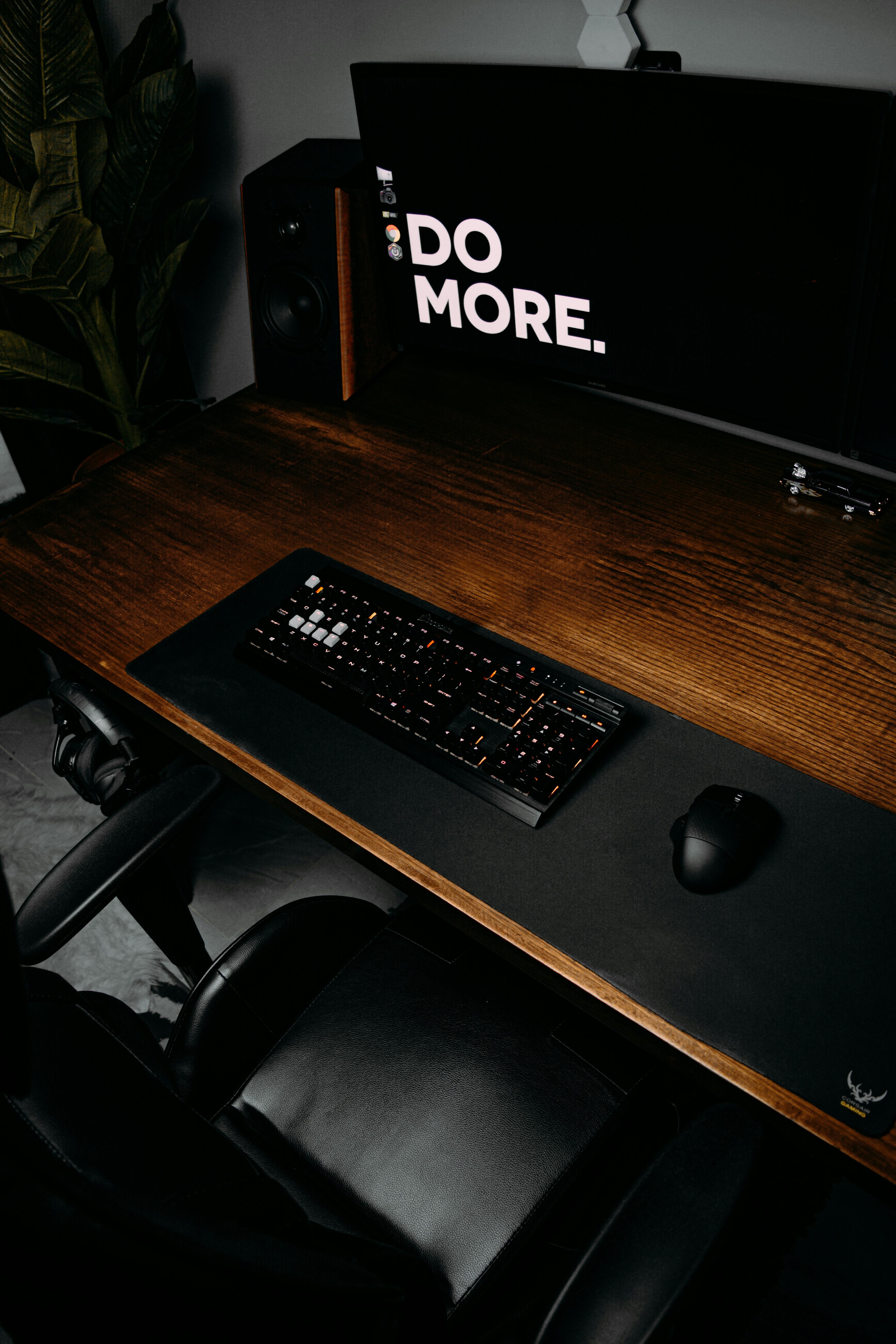 a computer on a desk with the words DO MORE on the screen