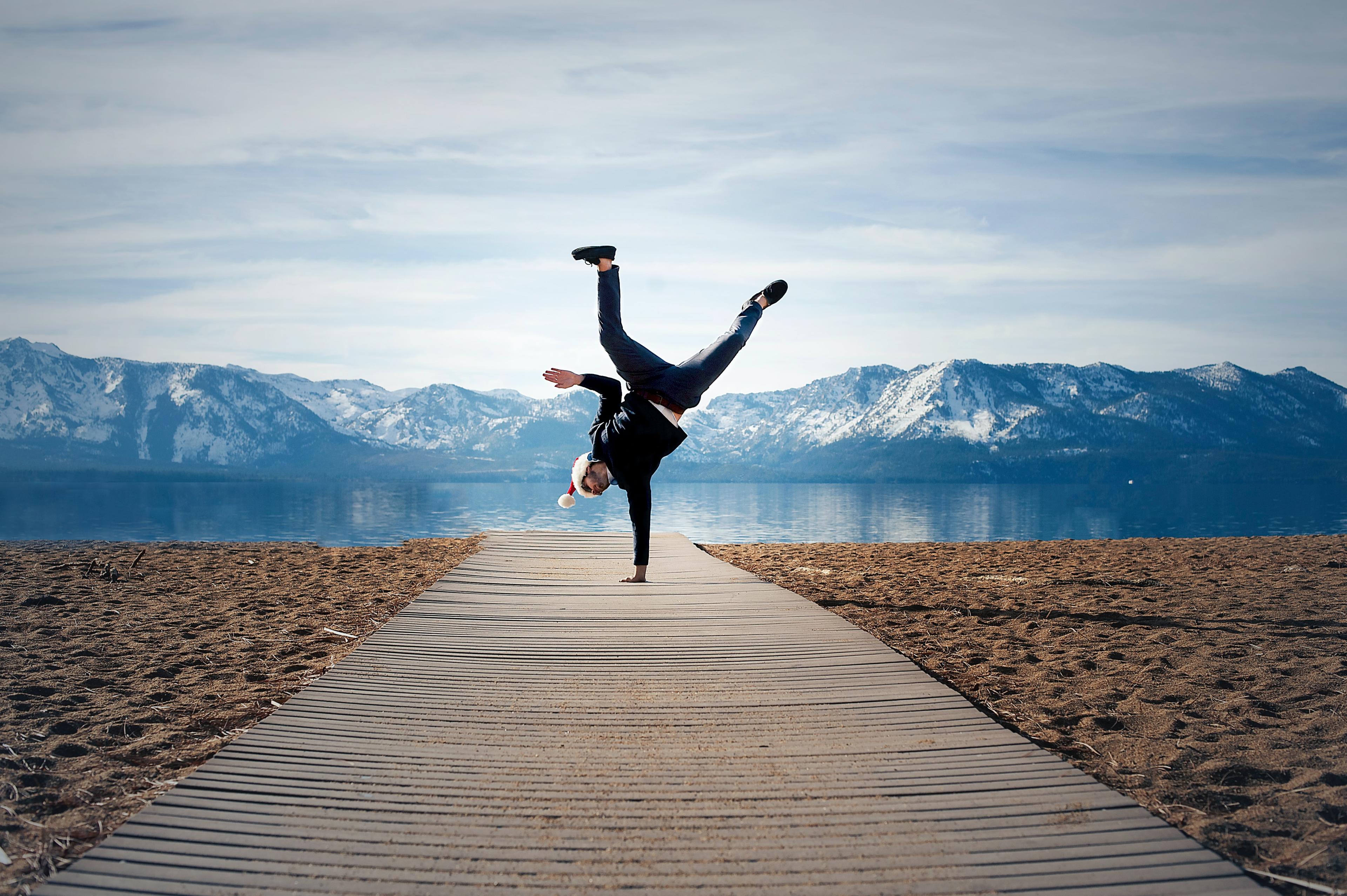 A woman doing a hand stand on a path