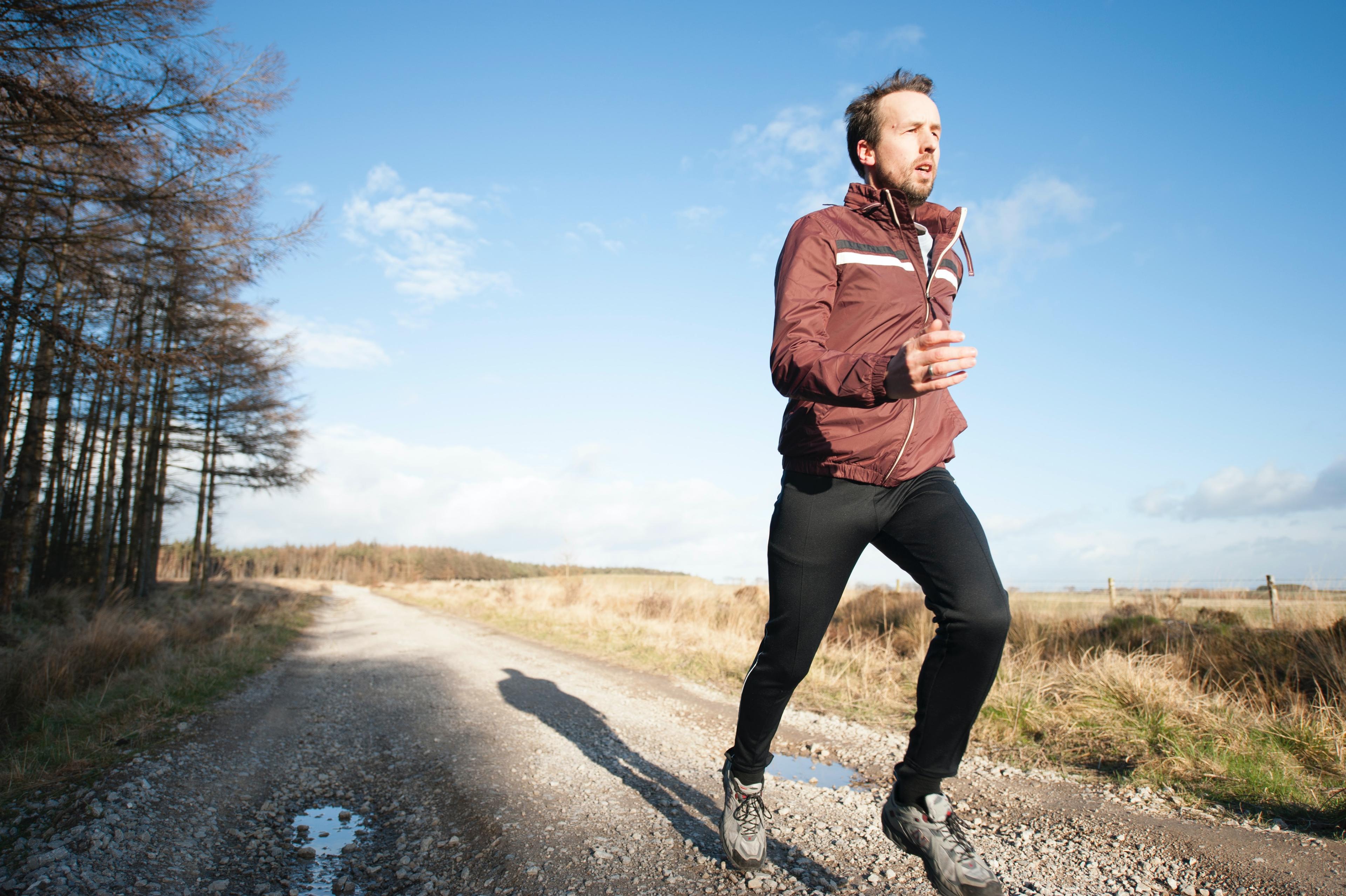 A man jogging down an empty path