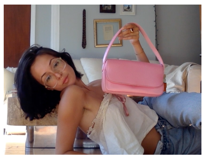 Actor Lauren Fern poses with her Hai Nelly Bag in Pink