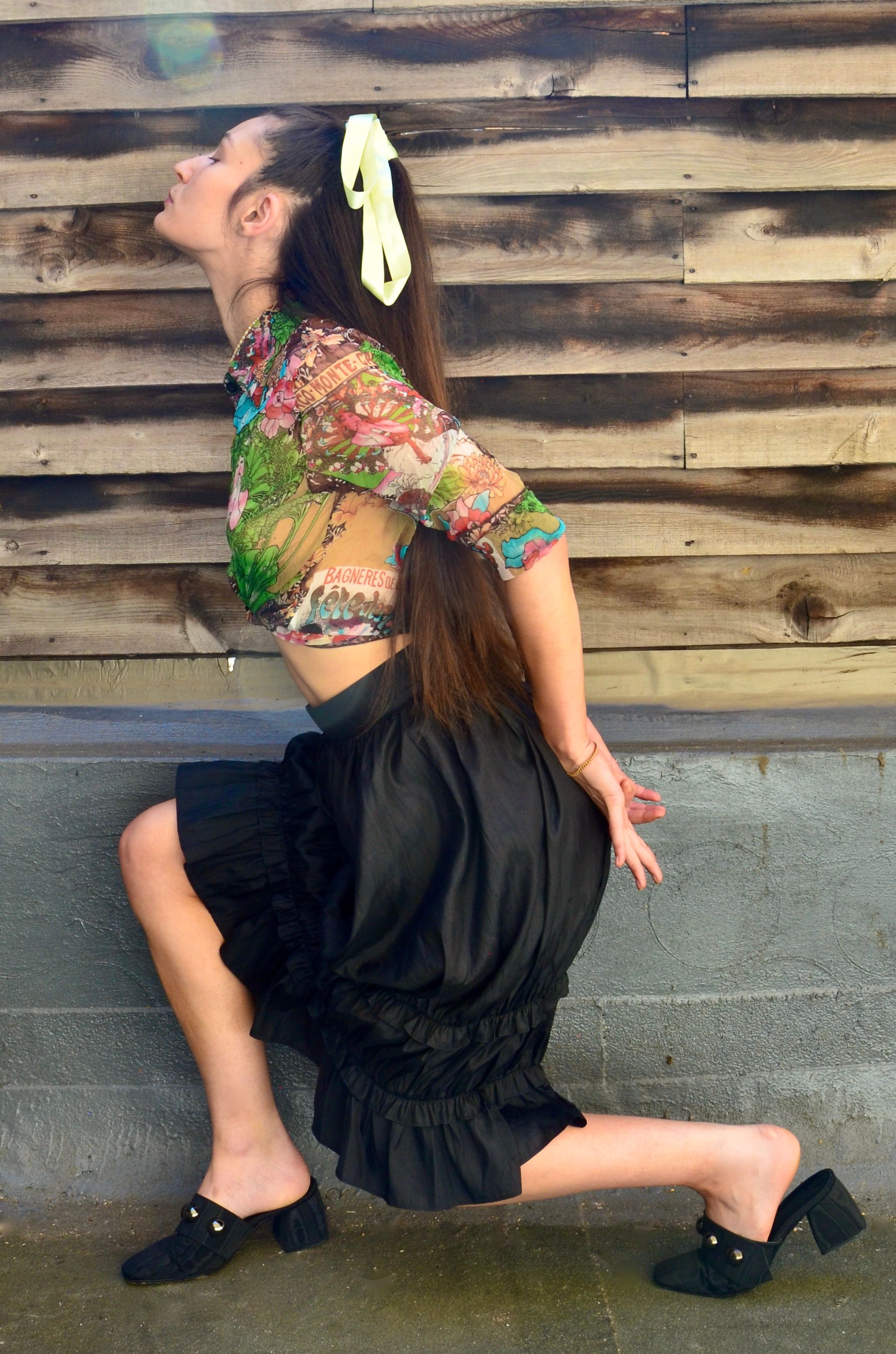 Model Ava Coffen poses in her Hai Maud Silk Ruffled Skirt in Black