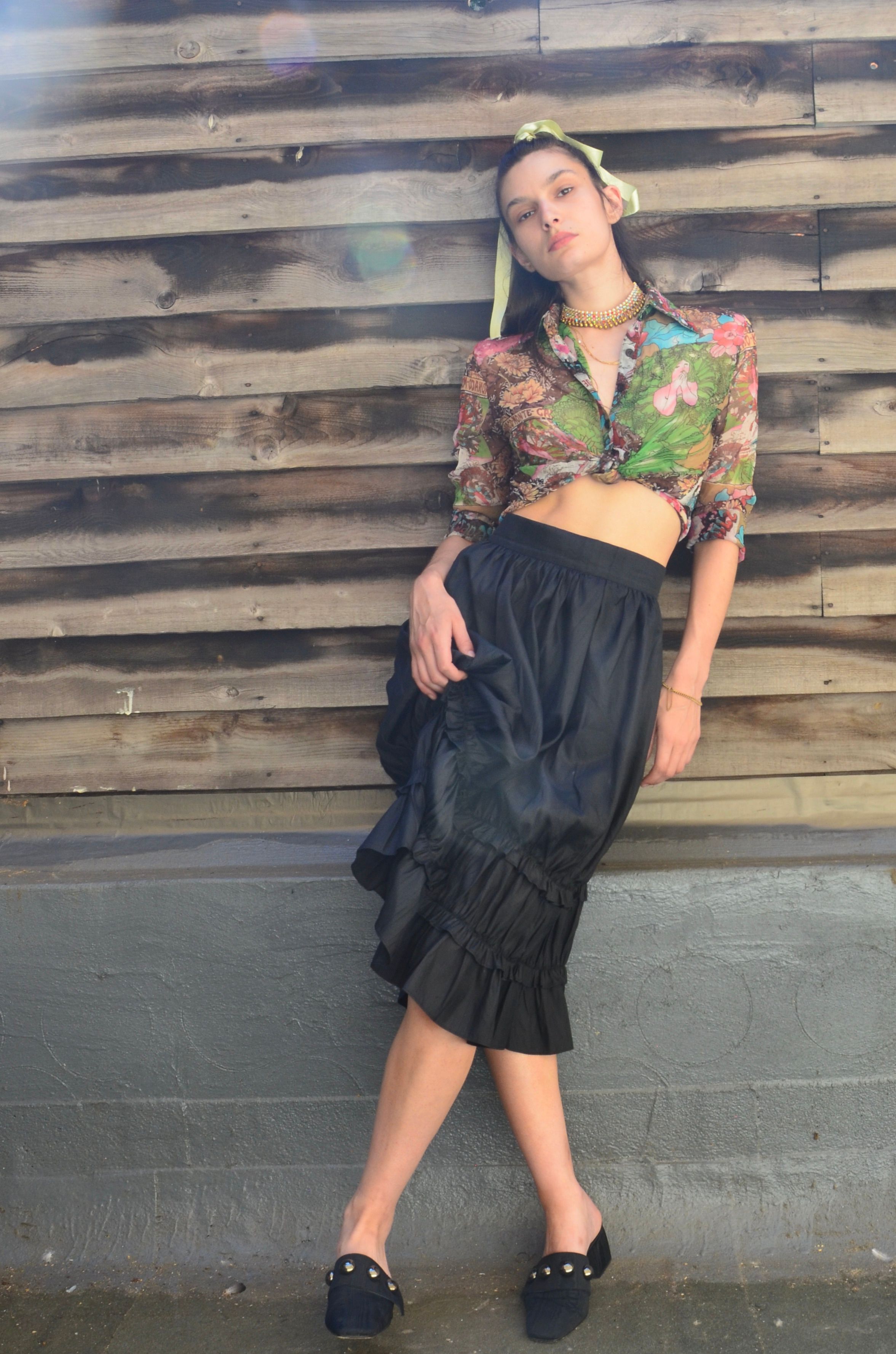Model Ava Coffen poses in her Hai Maud Silk Ruffled Skirt in Black
