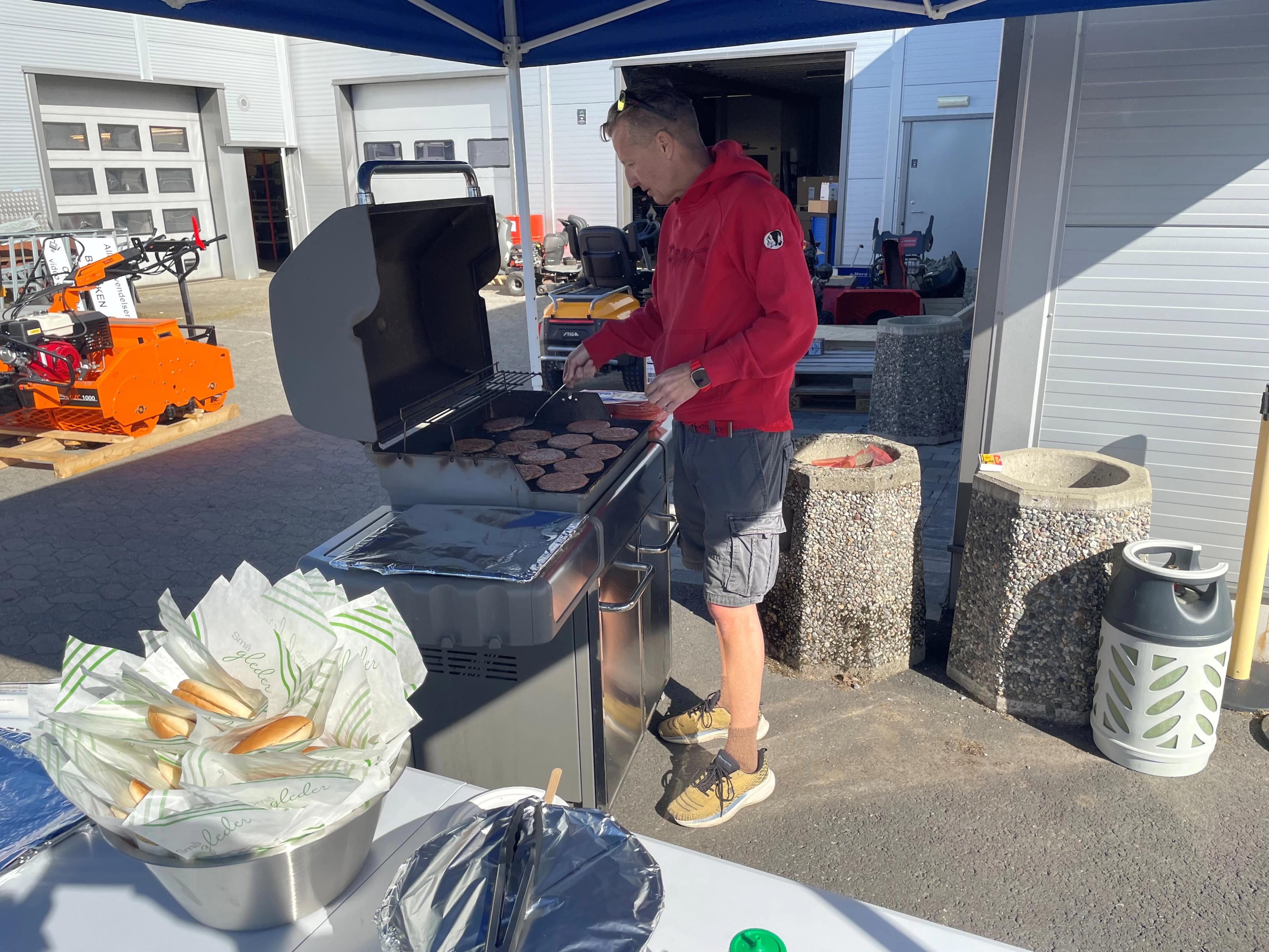 en mann som griller hamburger