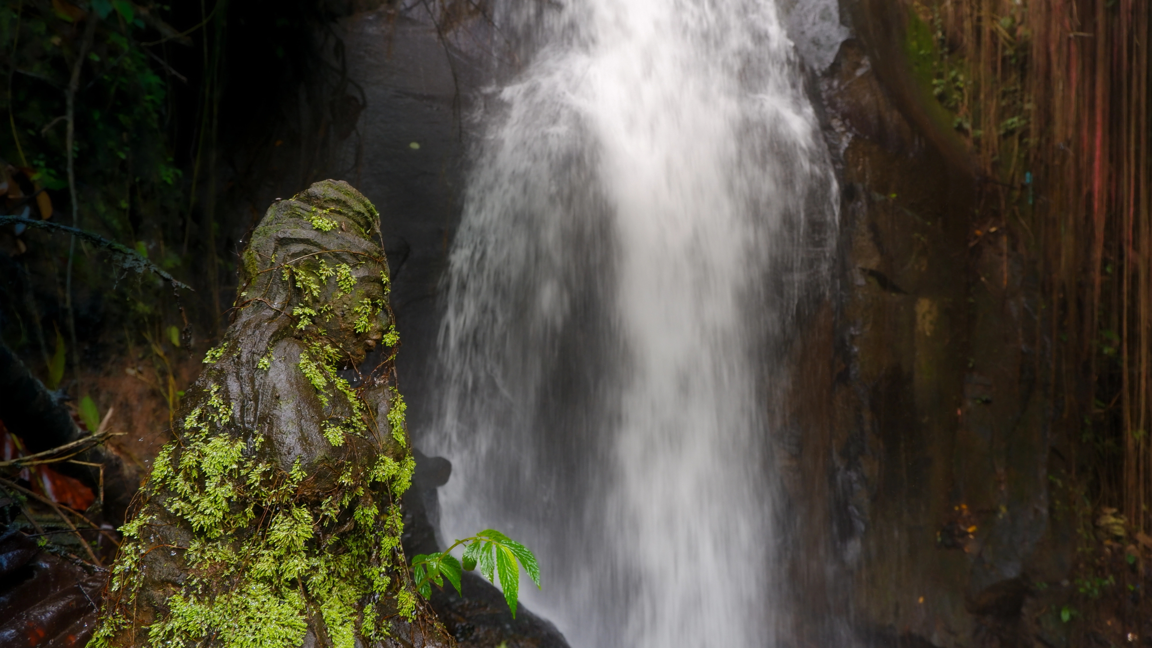 Image of waterfall in Ubud, and one sacred sculpture