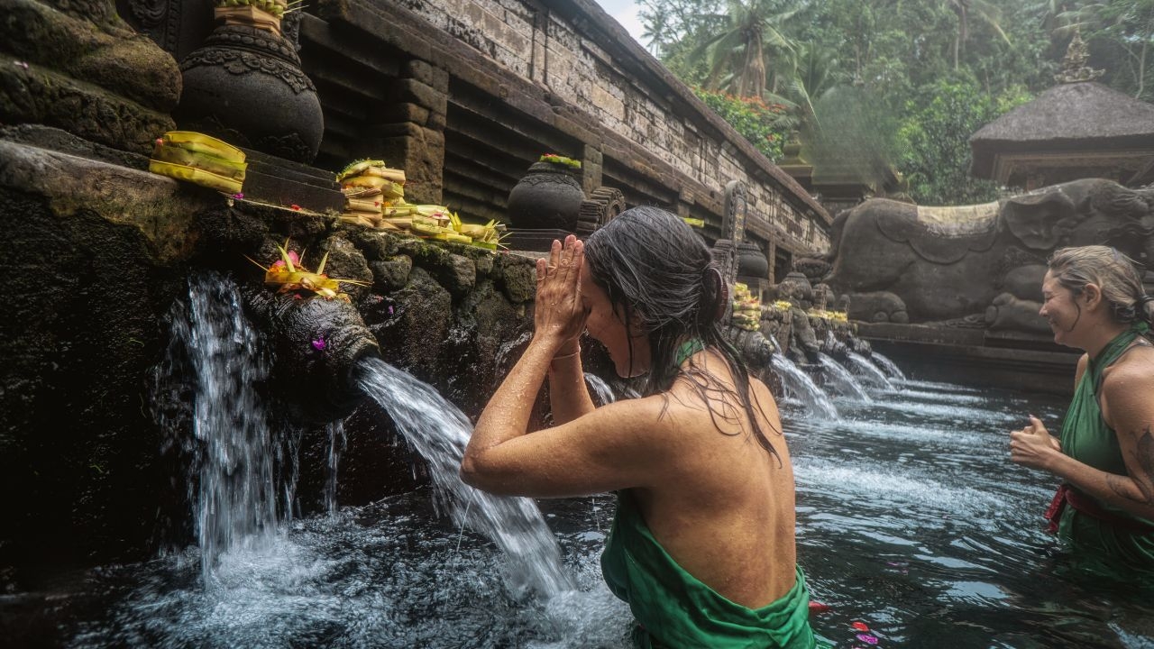 Image of woman in the sacred place during Melukat ceremony.