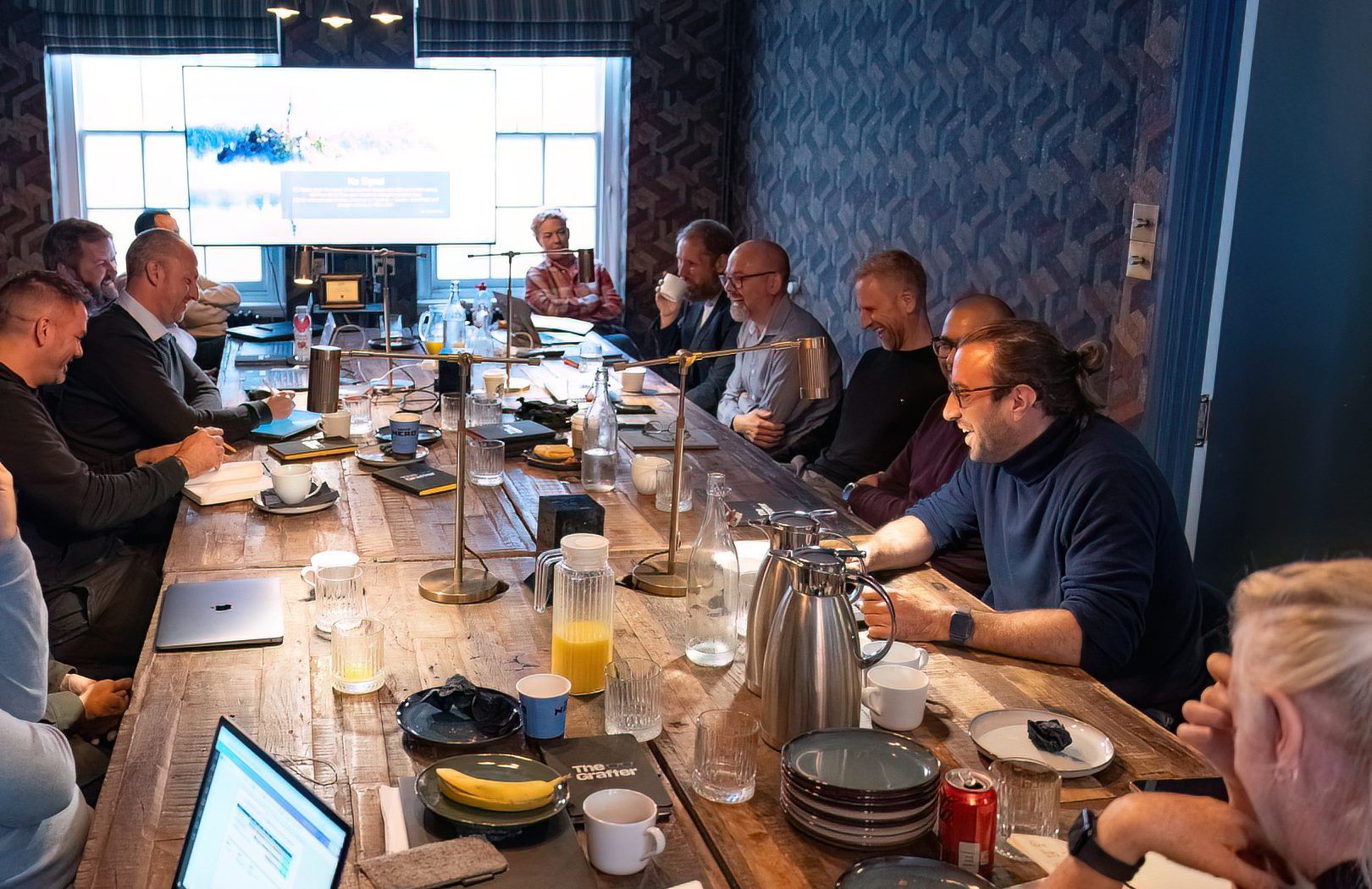 People sat around a long table in discussion