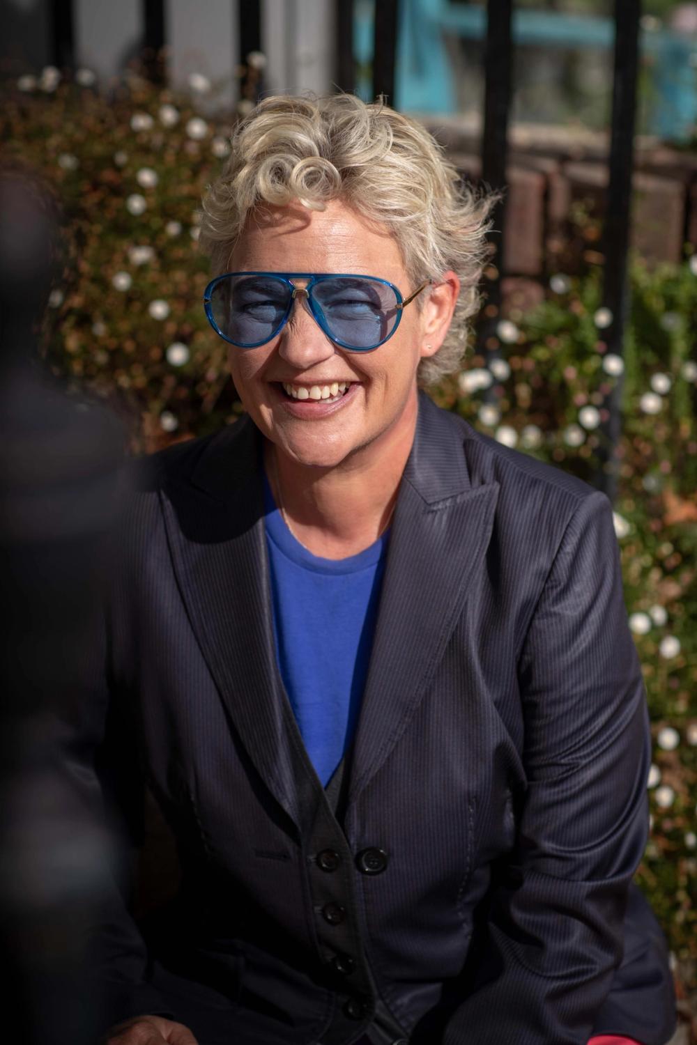 The Grafter's founder, Rachel Murphy smiling at the camera wearing blue sunglasses.