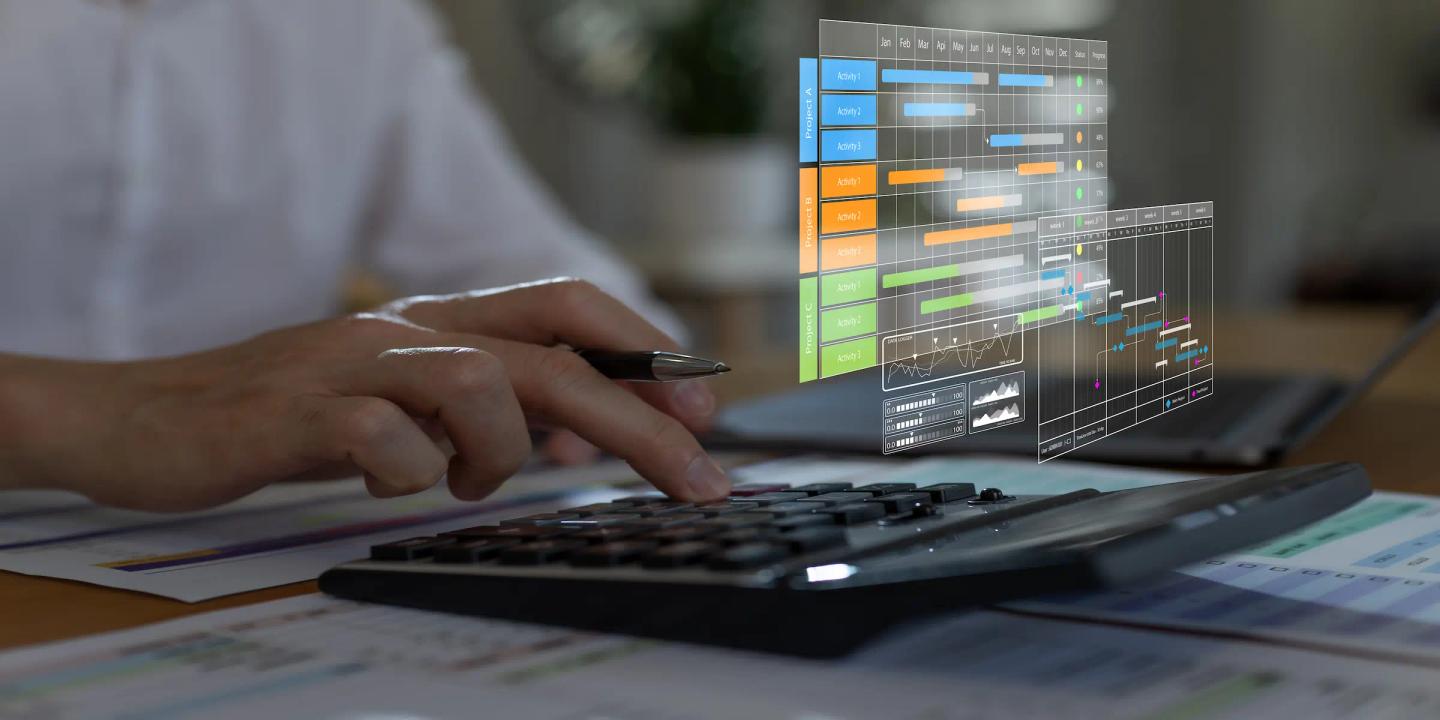 Person working on a software project with a digital project timeline displayed on screen