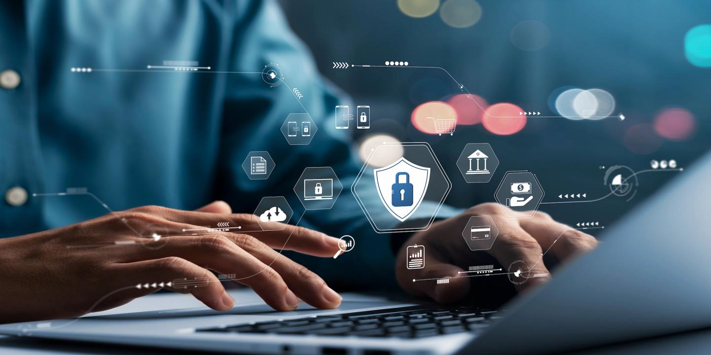 Person using a laptop with digital security icons representing data protection, payments, cloud storage and online privacy.