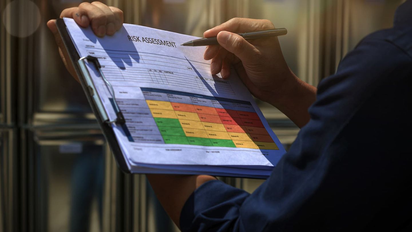 person checking a risk assessment chart