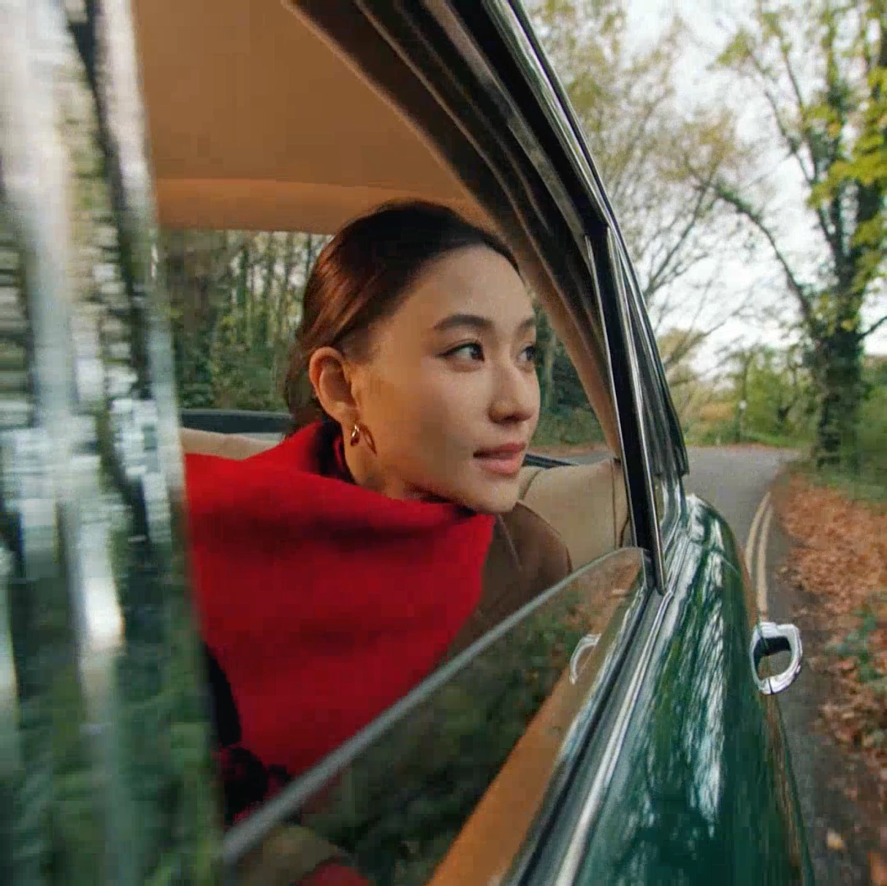 lady looking out of a classic car
