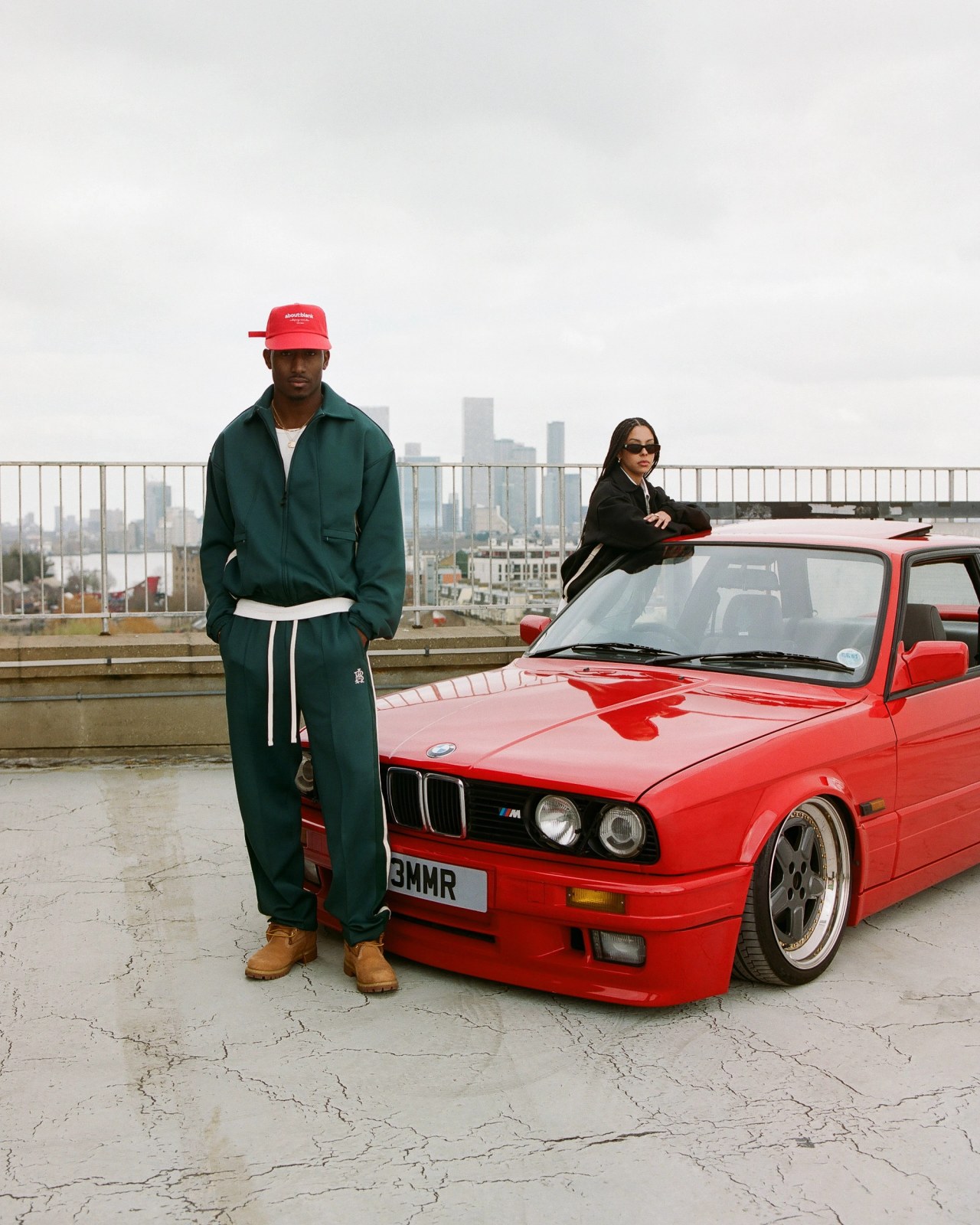 red classic bmw with models stood infront