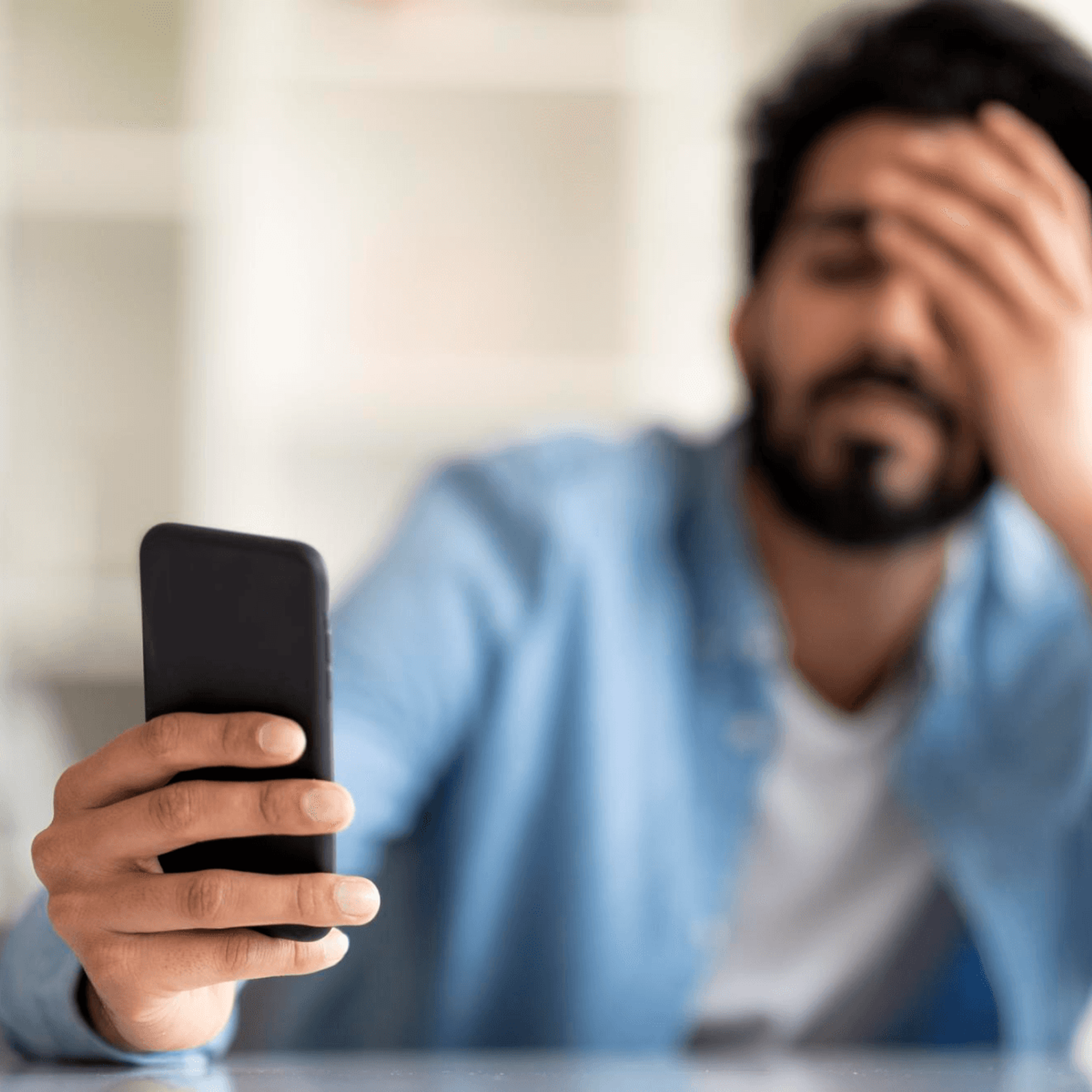 Frustrated shopper looking at his phone