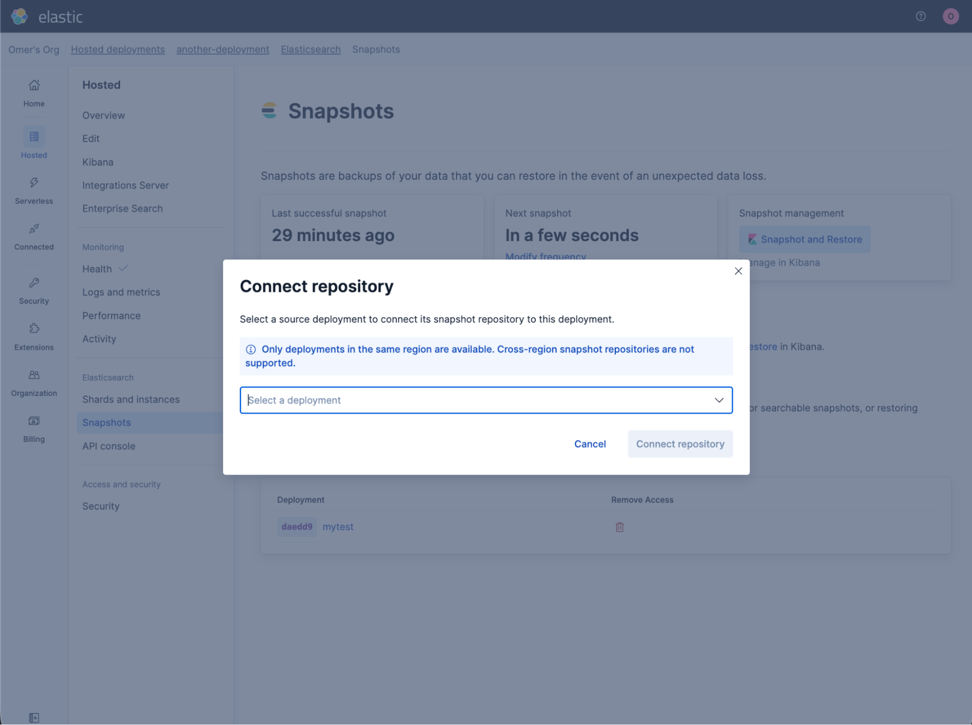 Elastic Cloud interface showing the Snapshots page with a modal titled “Connect repository.”  The modal includes a line: "Select a source deployment to connect its snapshot repository to this deployment." And the modal has a dropdown labeled “Select a deployment,” a note stating that only same‑region deployments are supported, and buttons for Cancel and Connect repository.