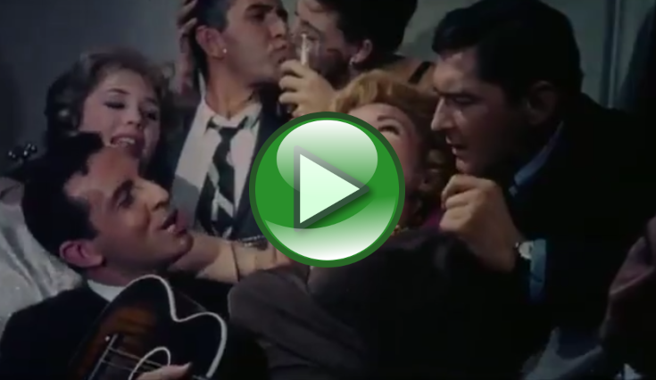  A video thumbnail showing several people gathered closely in a lively indoor setting, including one person holding a guitar while others appear to talk or laugh (score 0.2099).
