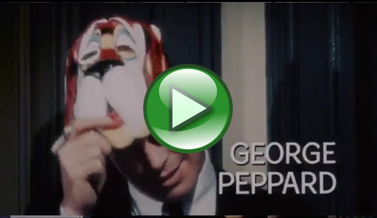 A video thumbnail showing a person holding a colorful mask near their face with the name “GEORGE PEPPARD” overlaid on the image (score 0.1237).