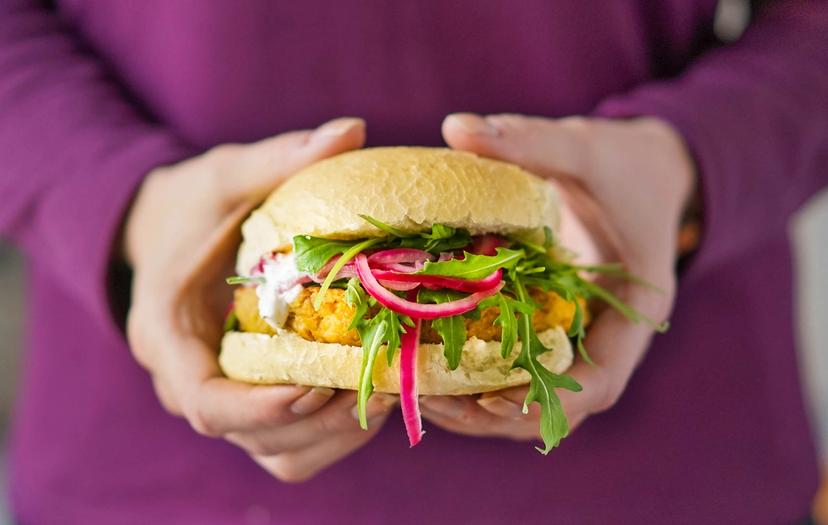 Vegetarburger holdes fram av en person