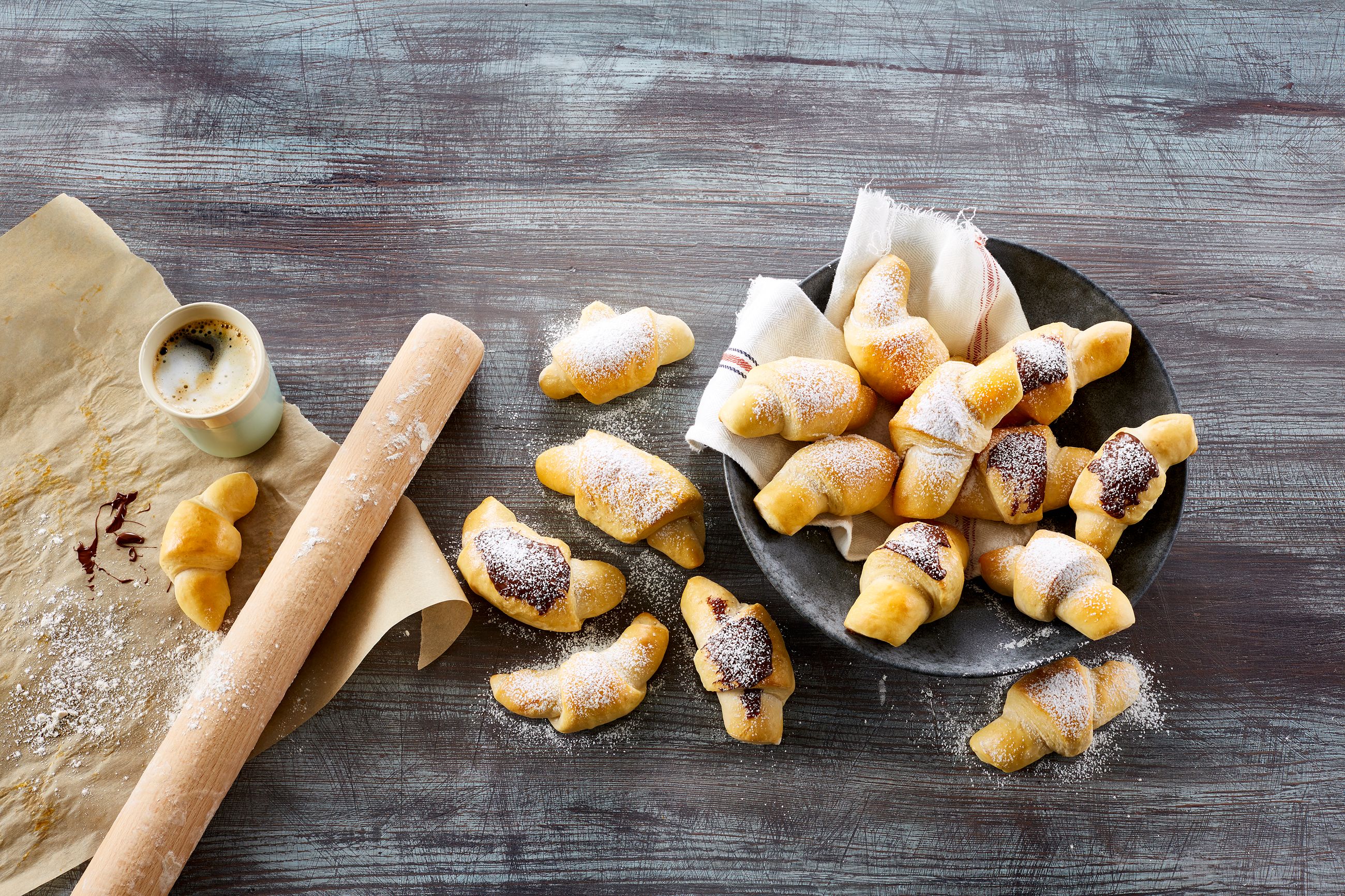 Kefirhorn med marsipan på et fat ved siden av en kopp kaffe