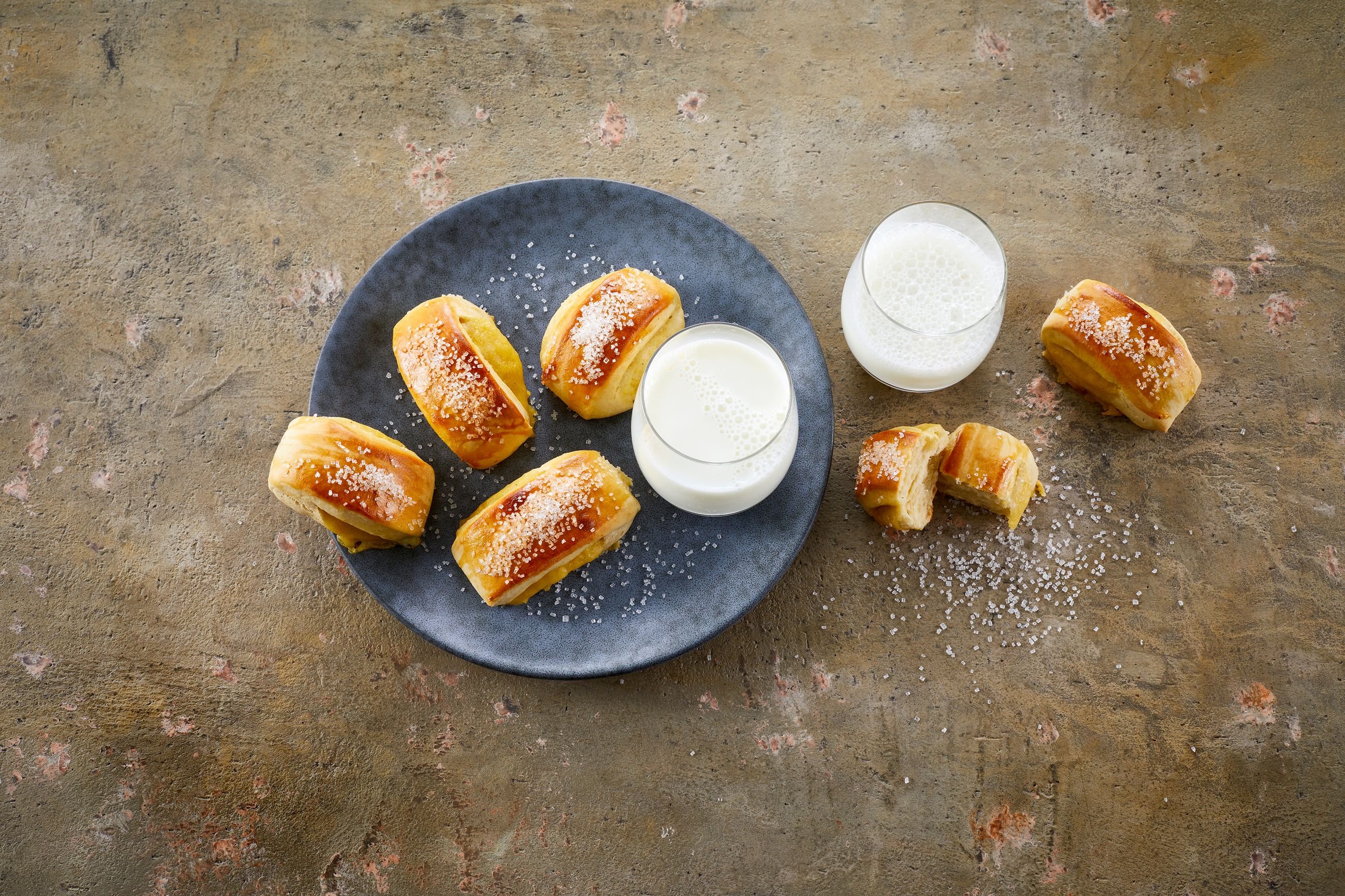 Vaniljestenger på en tallerken med to glass melk