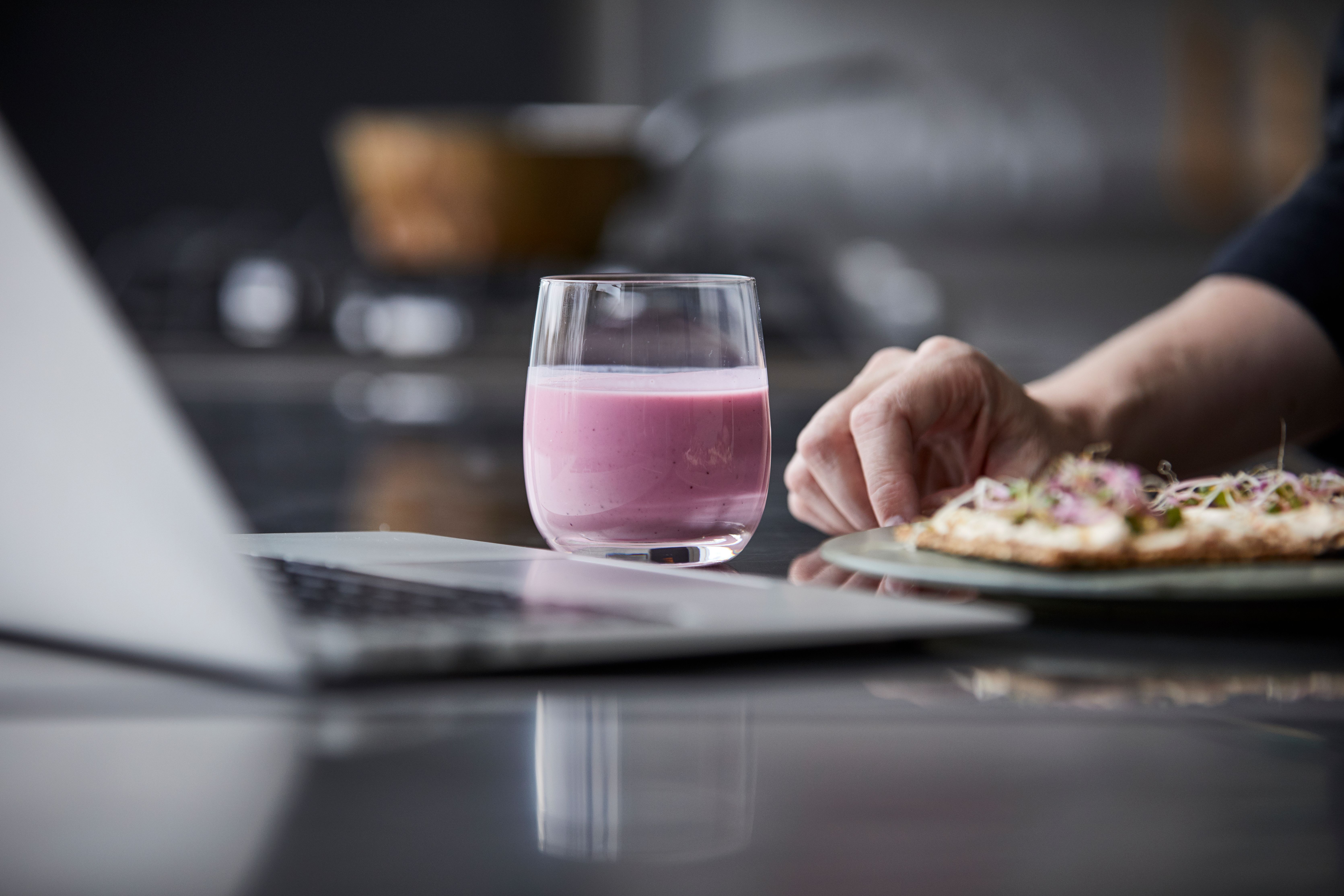 Tallerken med mat foran laptop