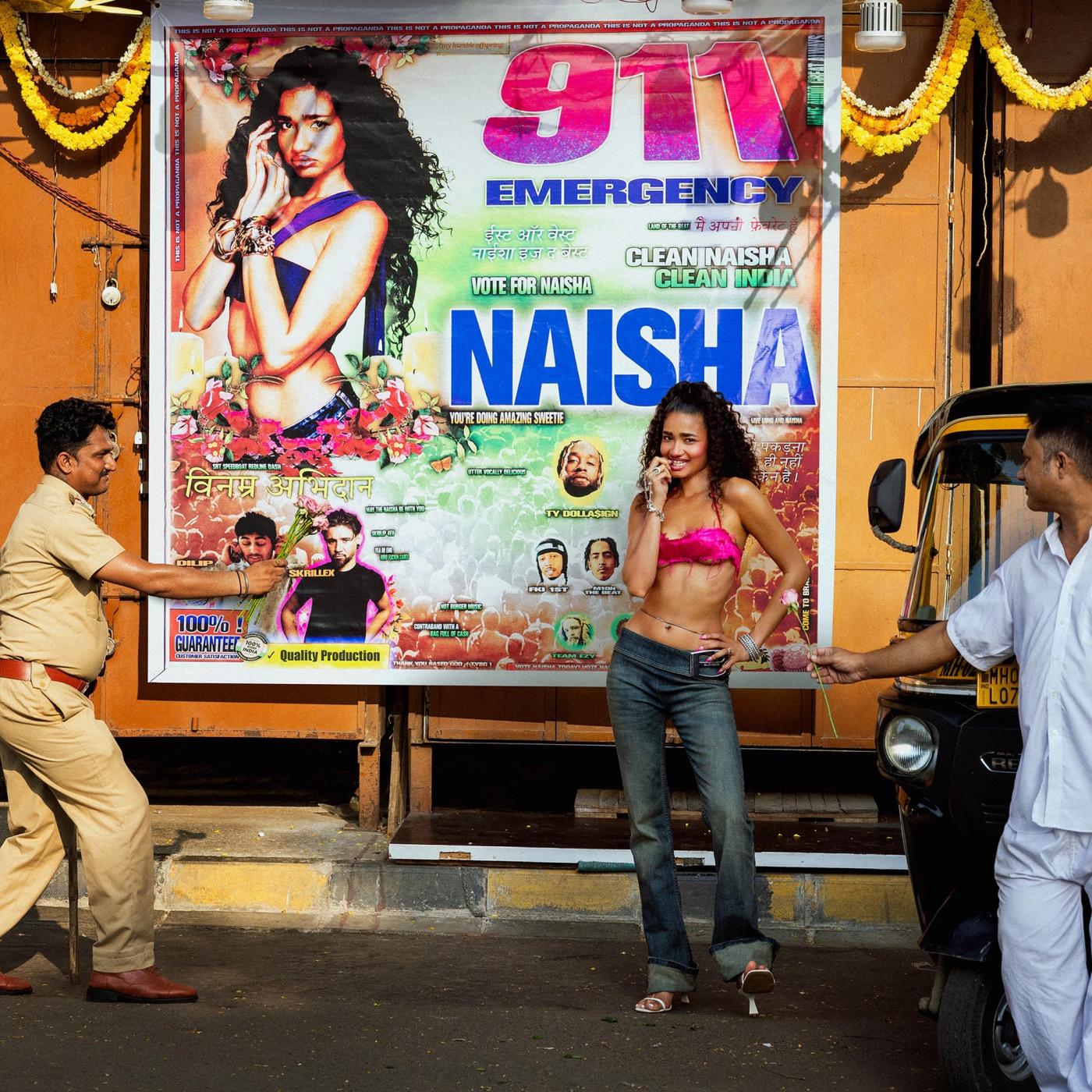 911 cover: Naisha in a pink top and jeans takes a call before a 911 Emergency poster bearing her name as two men in uniform reach toward her
