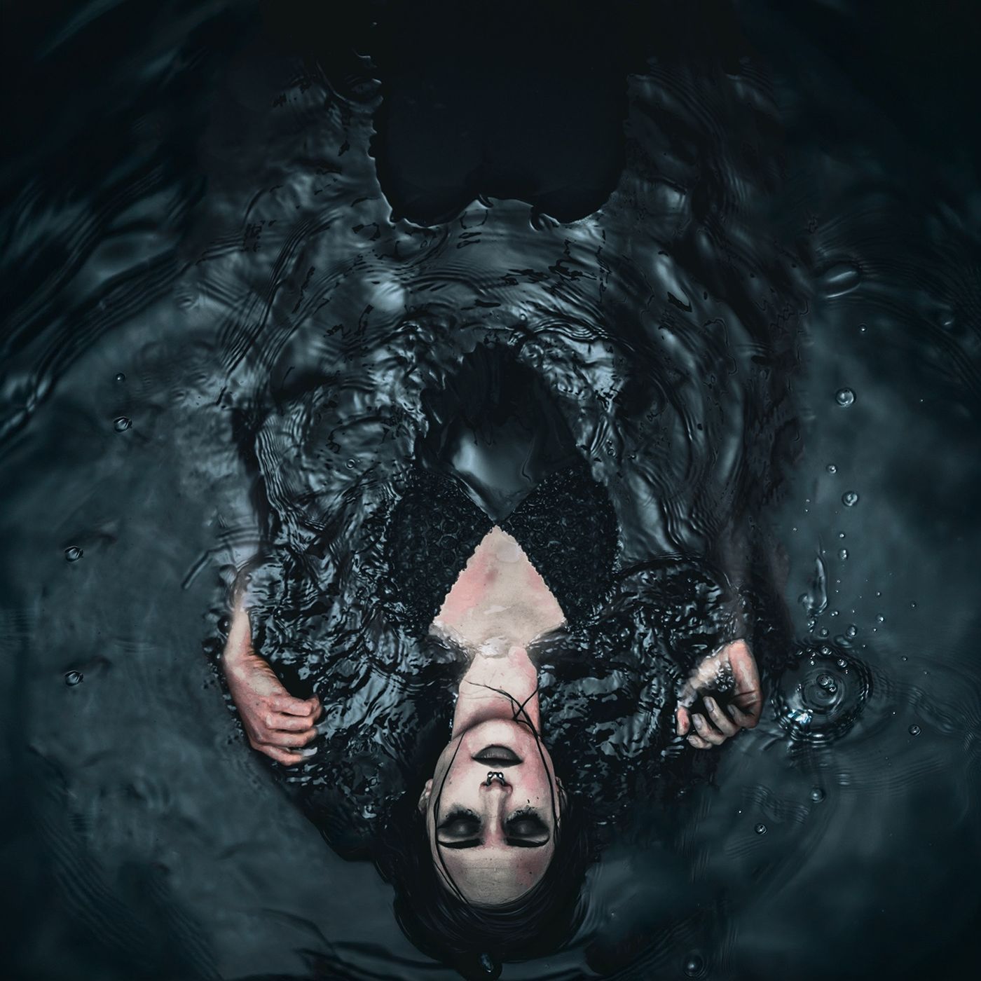 A figure lies in dark water wrapped in dark fabric on the She Let The World Run Rampant cover