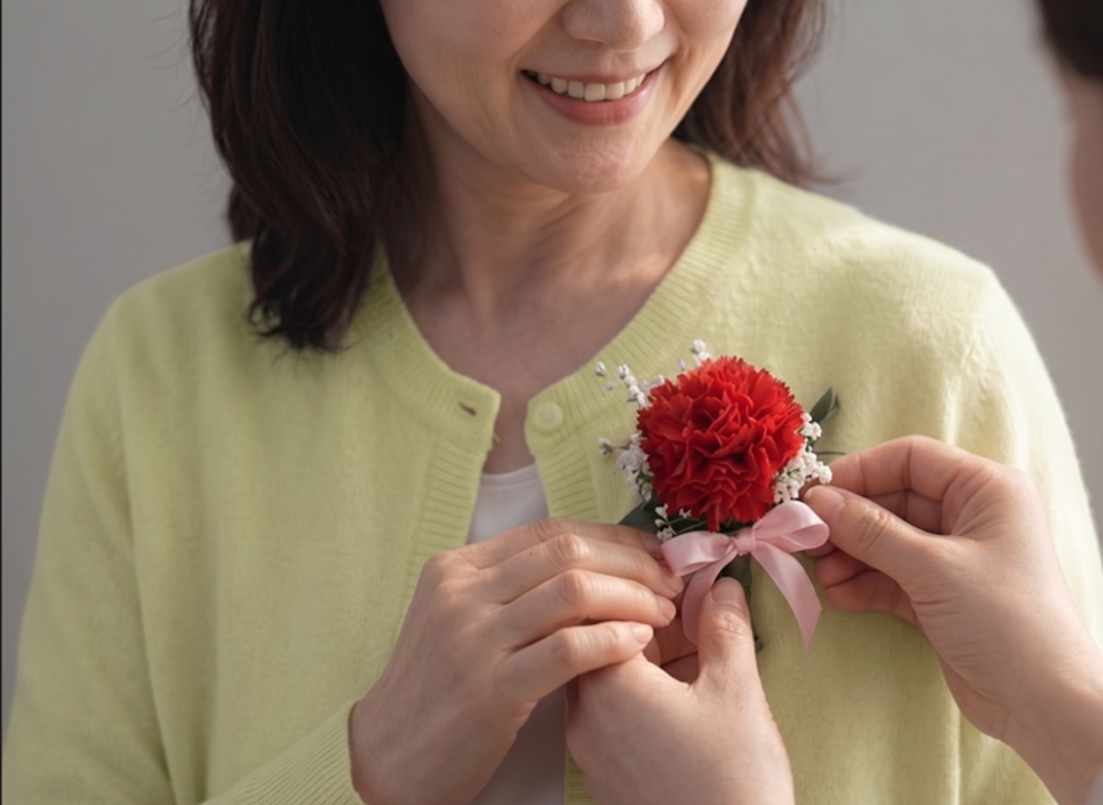 a child who puts carnations on his mother's left chest