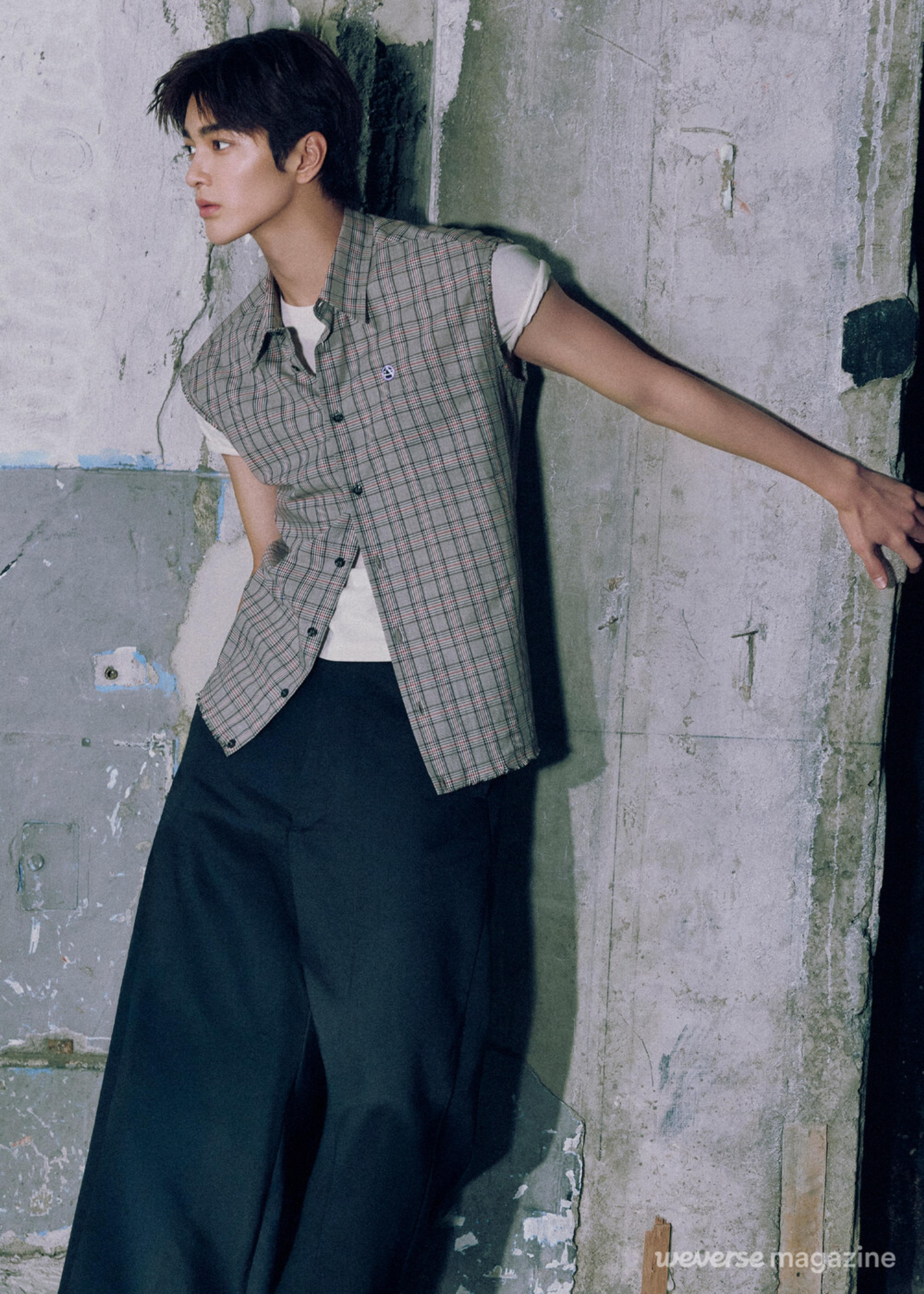 Keonho of CORTIS leaning against an industrial wall in an official Weverse Magazine portrait