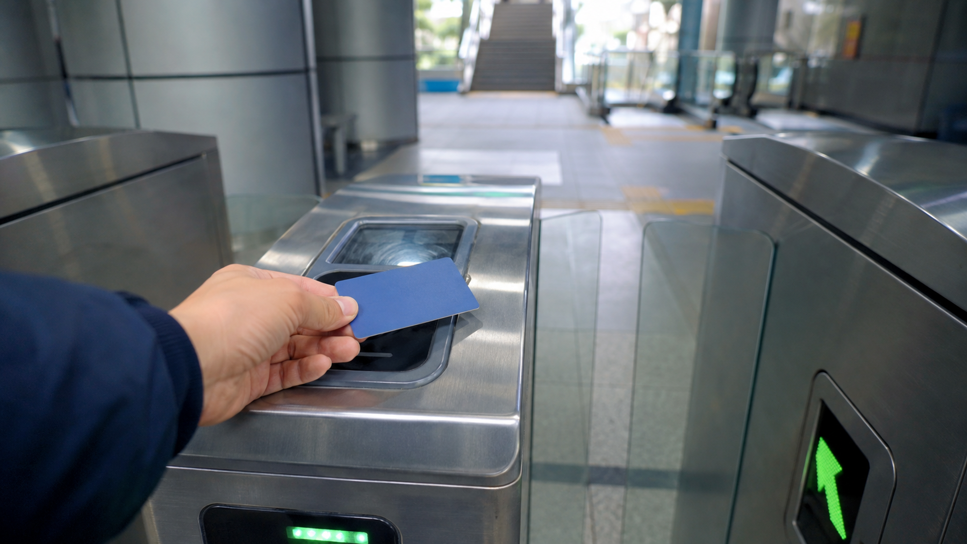 A traveler tapping a prepaid transit card at a subway fare gate in Seoul