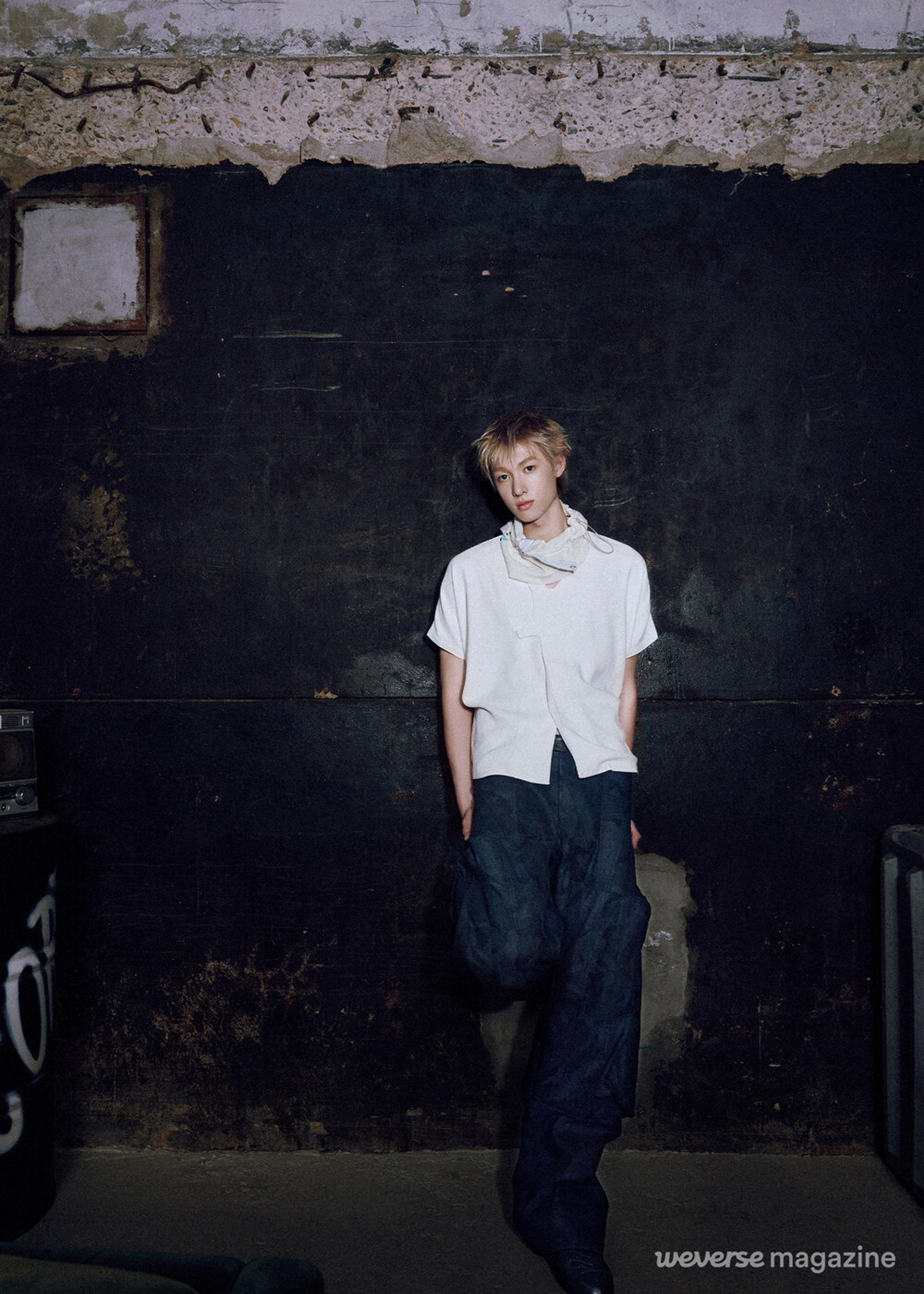 Martin of CORTIS standing against a dark industrial wall in an official Weverse Magazine portrait