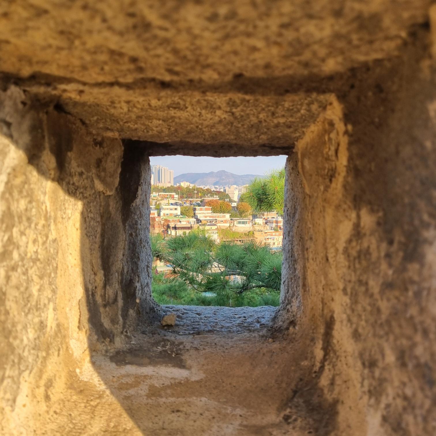 framed view of Seoul through the ancient stone wall.
