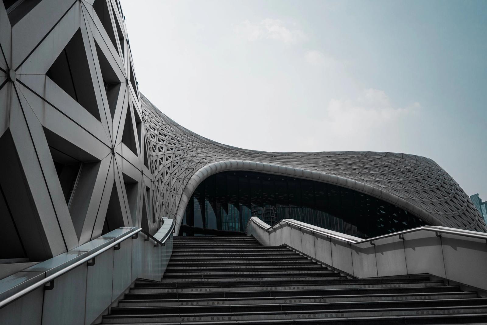 Modern architecture with geometric patterns, a staircase, and a dynamic facade.