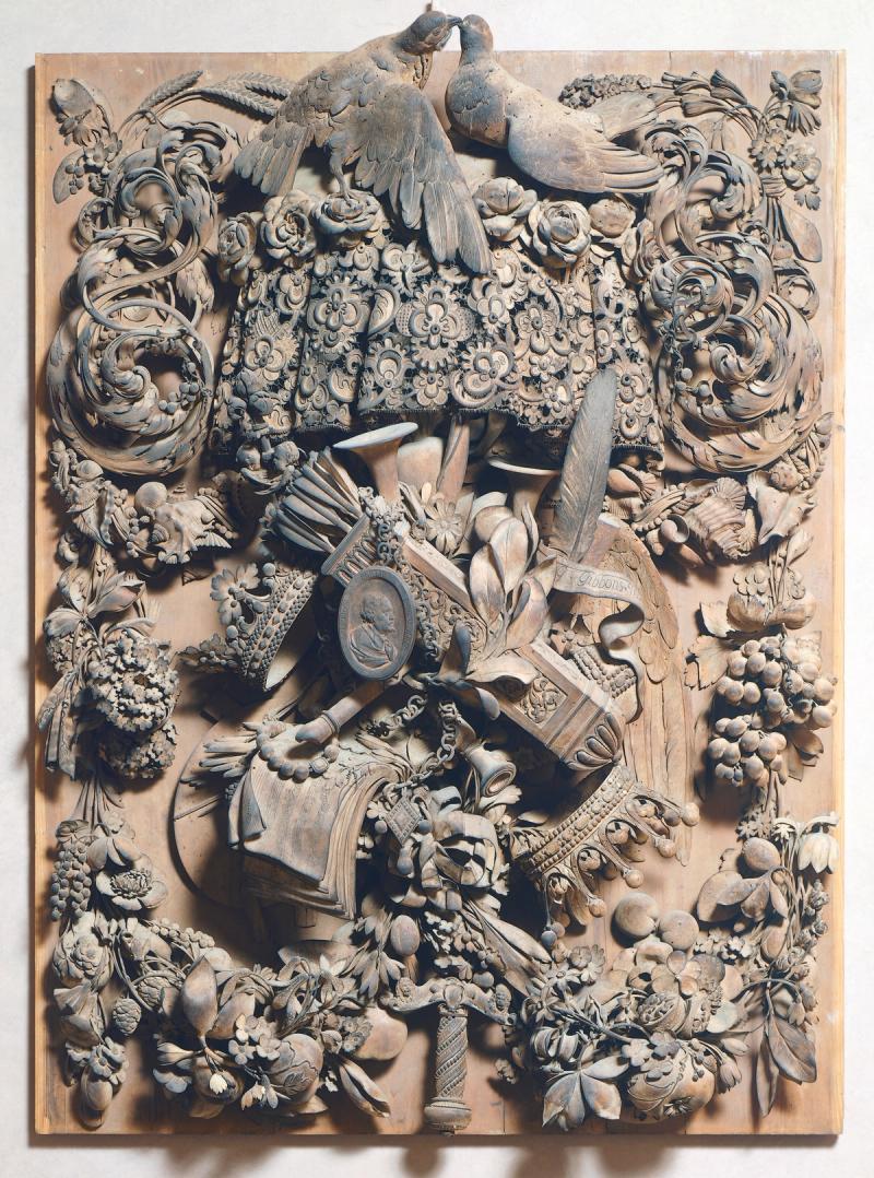Gibbons’ limewood panel, carved with leaves, shells, a lace cravat and instruments.