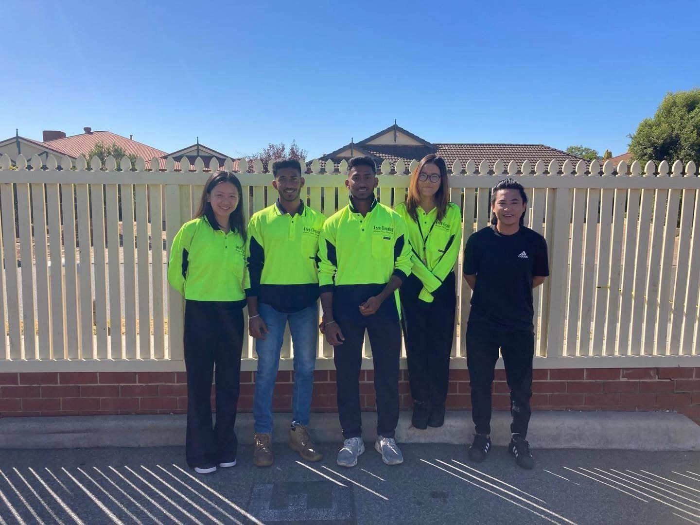 Keen Cleaning team members in uniform standing together outdoors