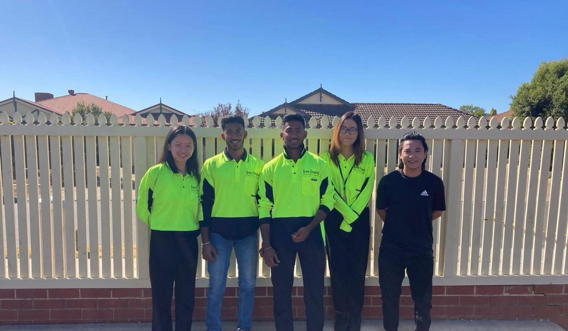 Keen Cleaning team members in uniform standing together outdoors