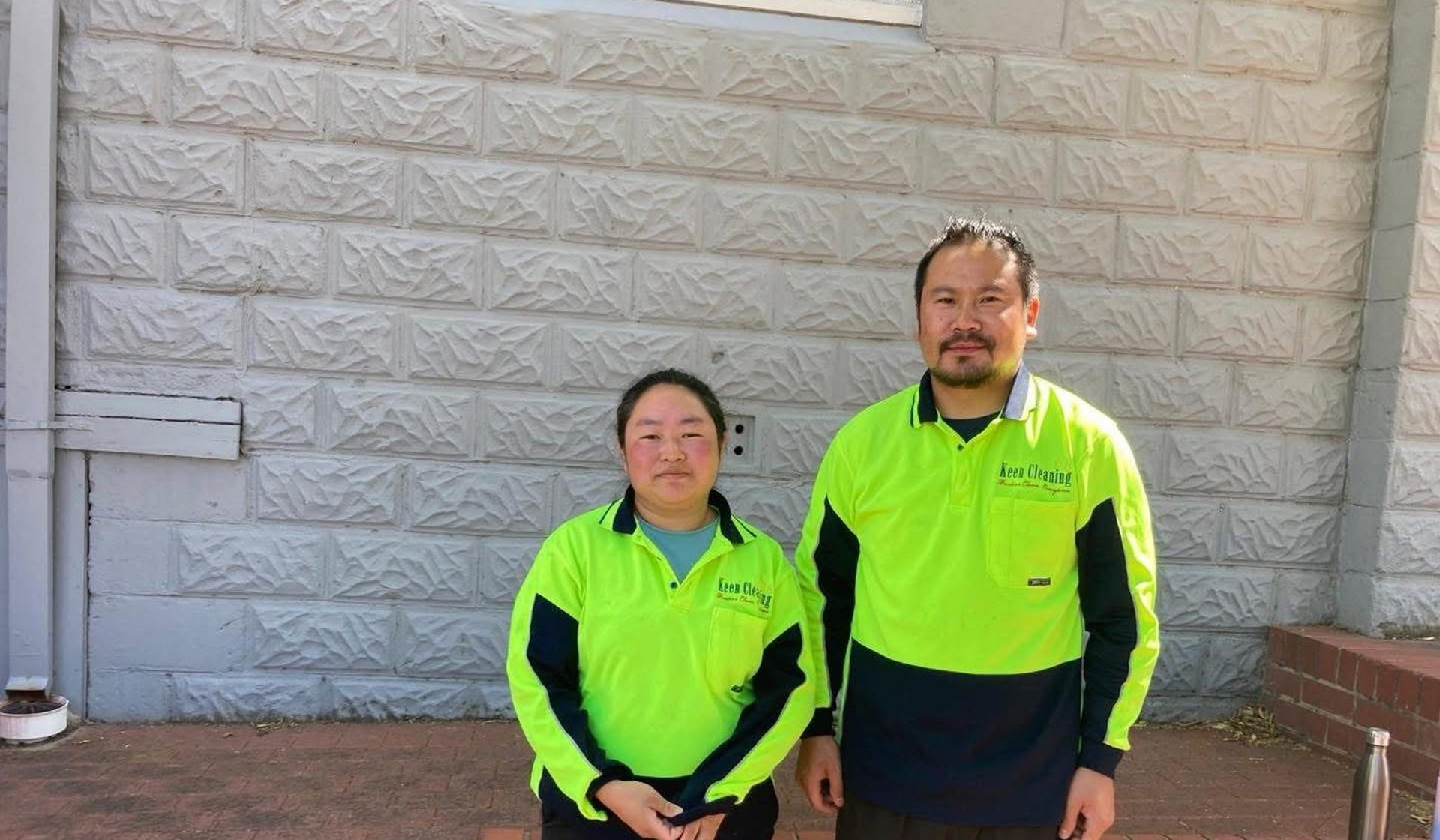 Two Keen Cleaning staff members in high-visibility uniforms