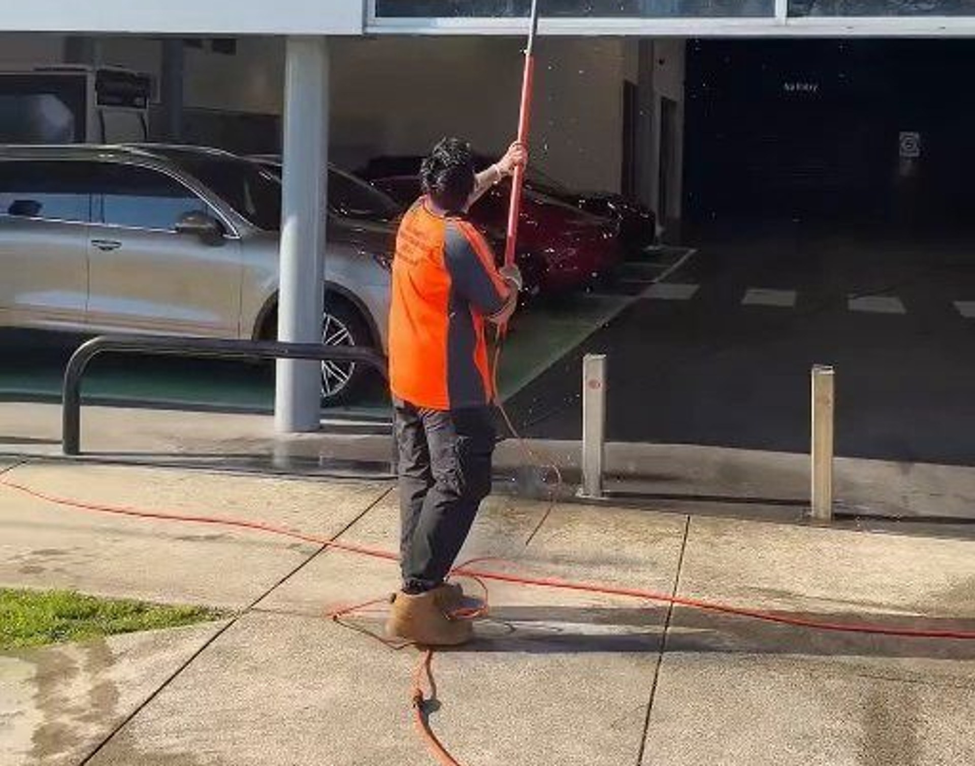 High-reach water-fed pole cleaning second-storey commercial windows