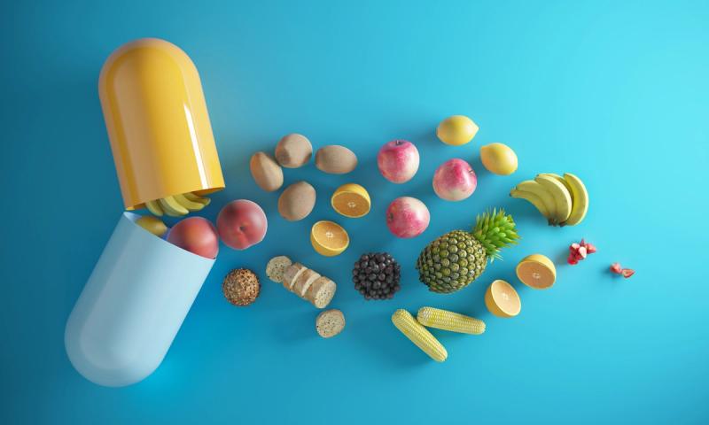 Hälsosamma livsmedel kommer ur ett vitaminpiller