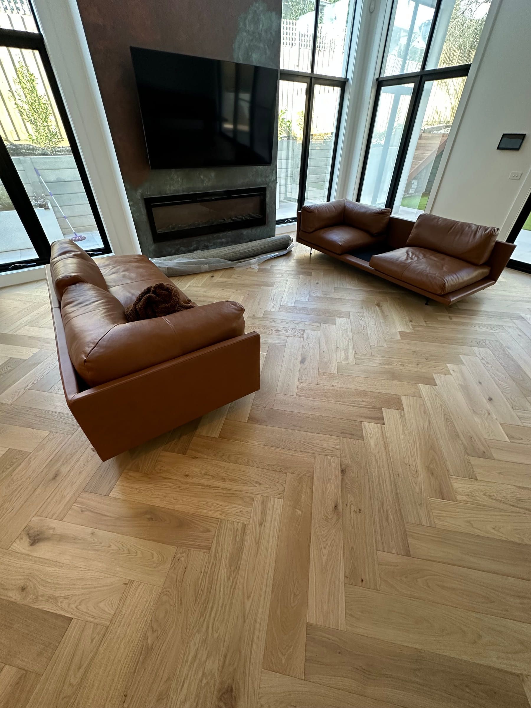 GrandOak Natural Oak herringbone flooring across a glazed Canterbury living room.