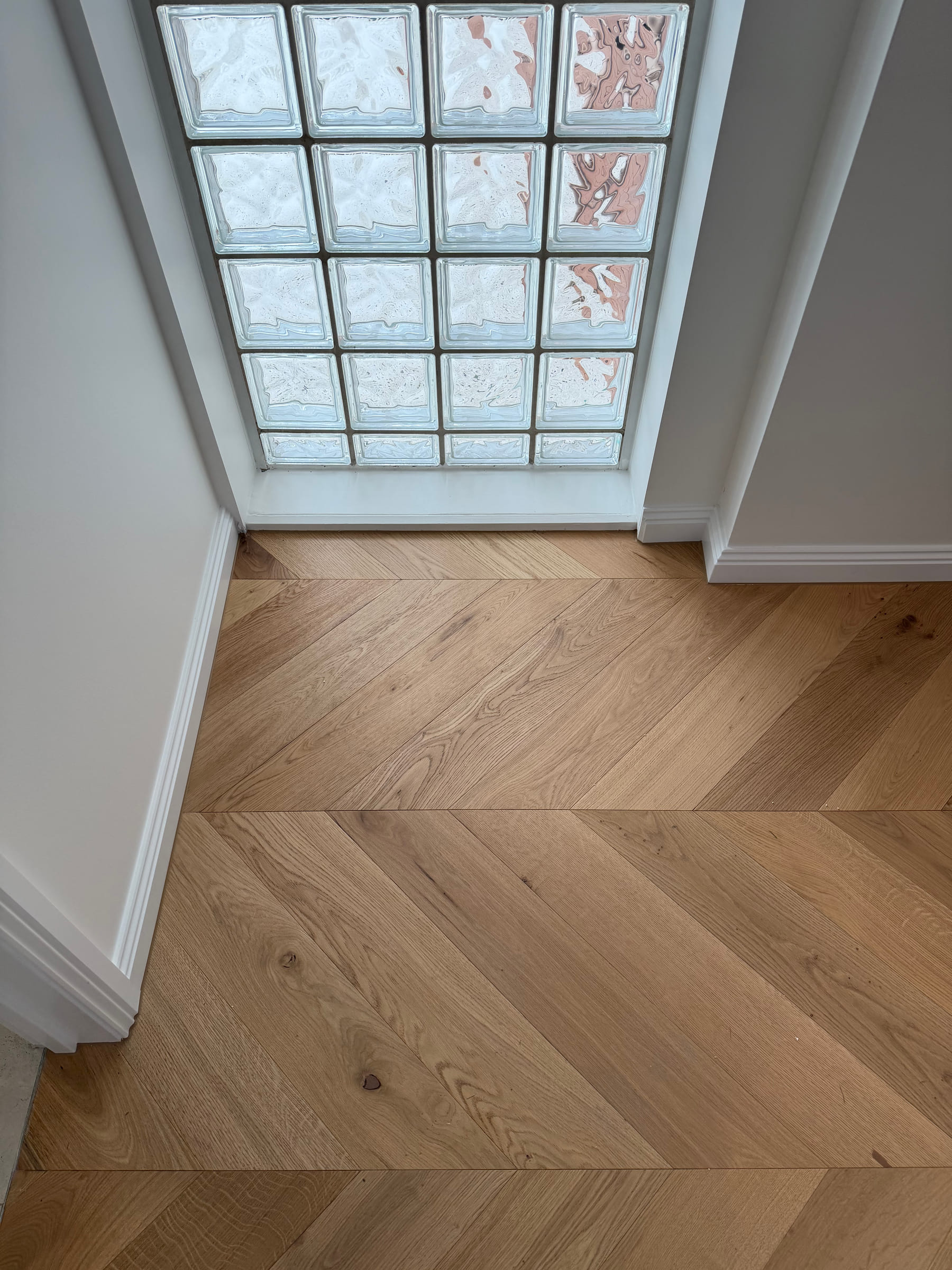 Natural Oak chevron flooring at the glass-block window and hallway junction in Bulleen.