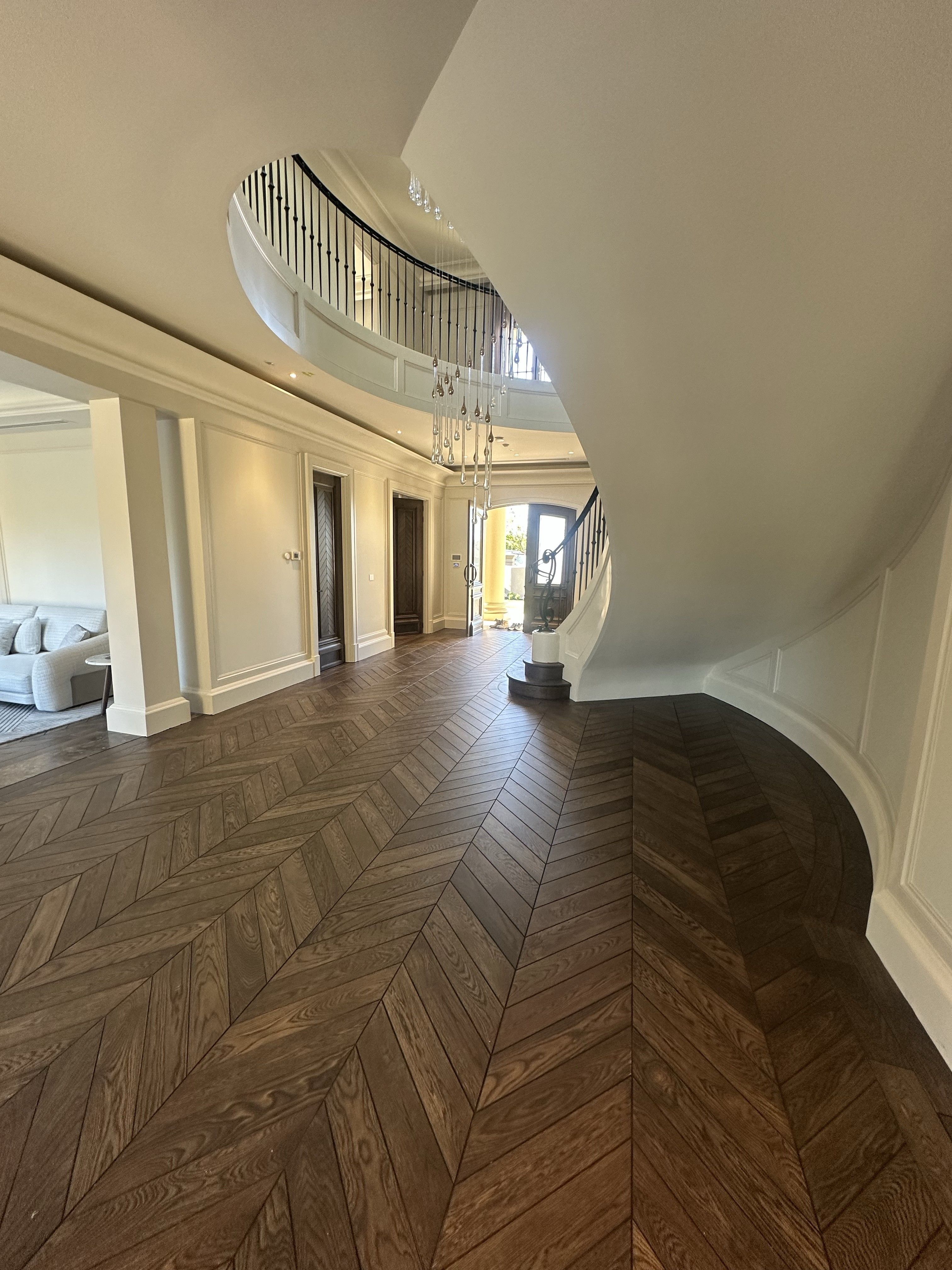 Solid European oak chevron flooring following a curved hallway in Balwyn North.