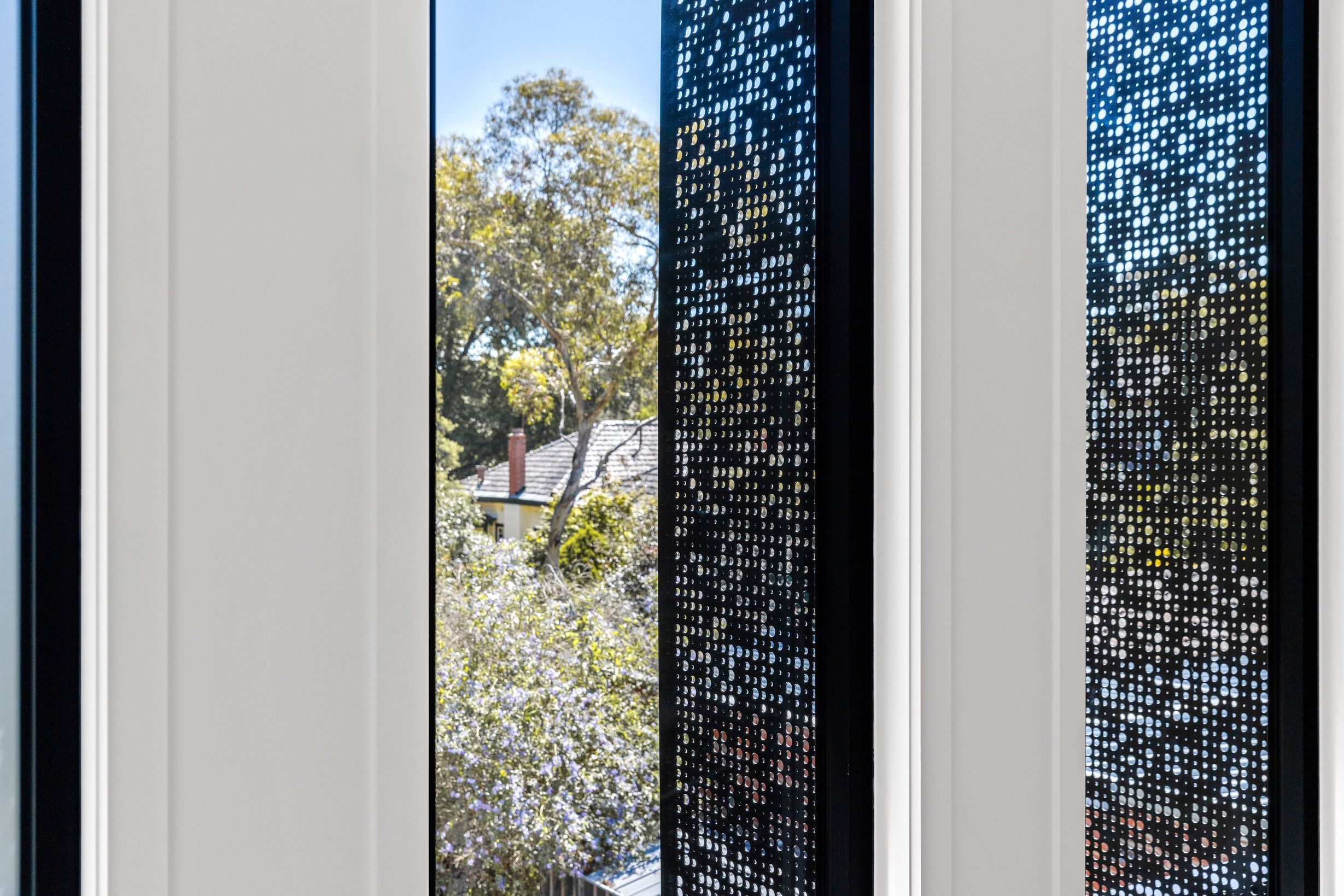 Architectural window screen detail in the completed Glen Iris residence.