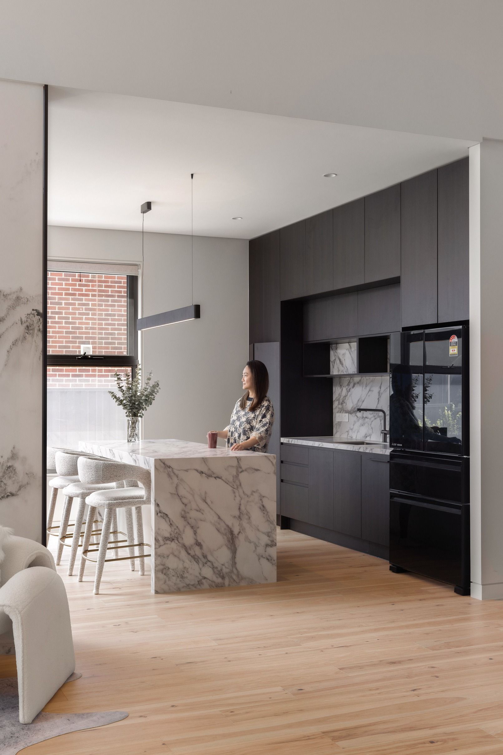 Danehill Hickory flooring leading into a black and white Wheelers Hill kitchen.