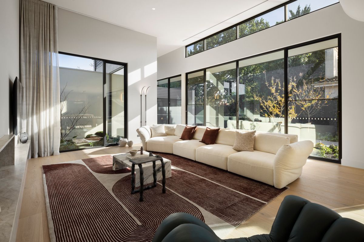 Avoca Bay oak flooring beside full-height glazing in a Kew living area.