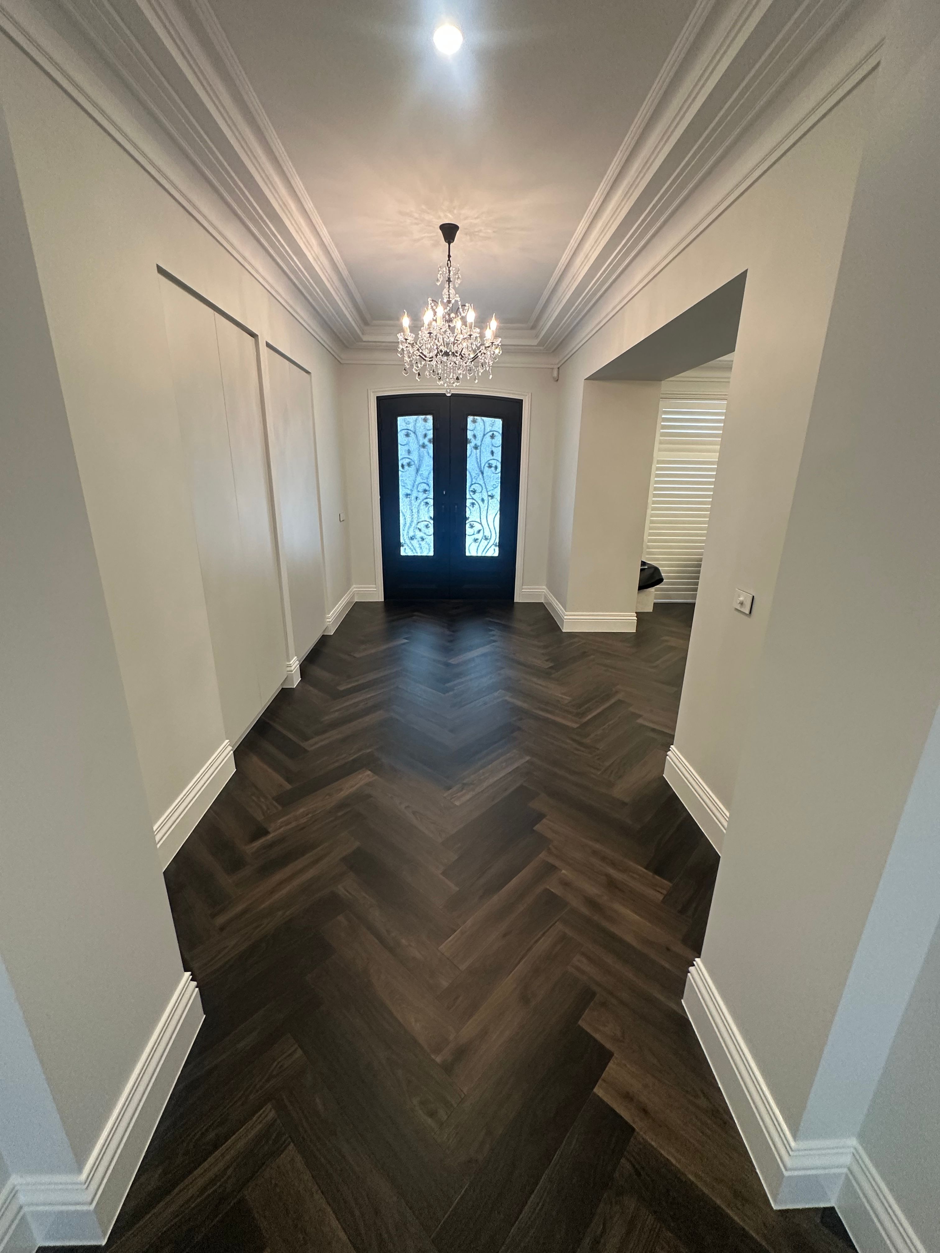 Ash Grey herringbone flooring aligned through the entrance hallway of a Camberwell home.