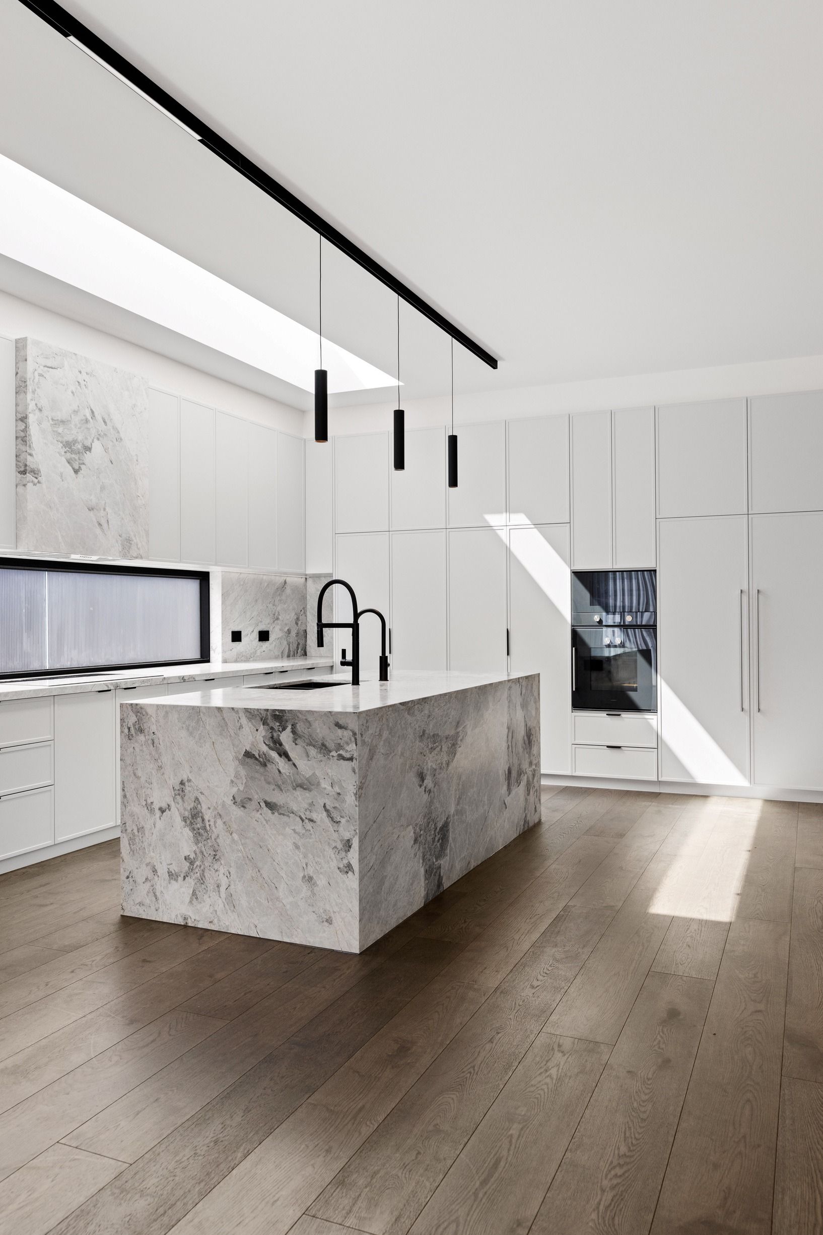 French Grey oak flooring around a marble kitchen island in Glen Iris.