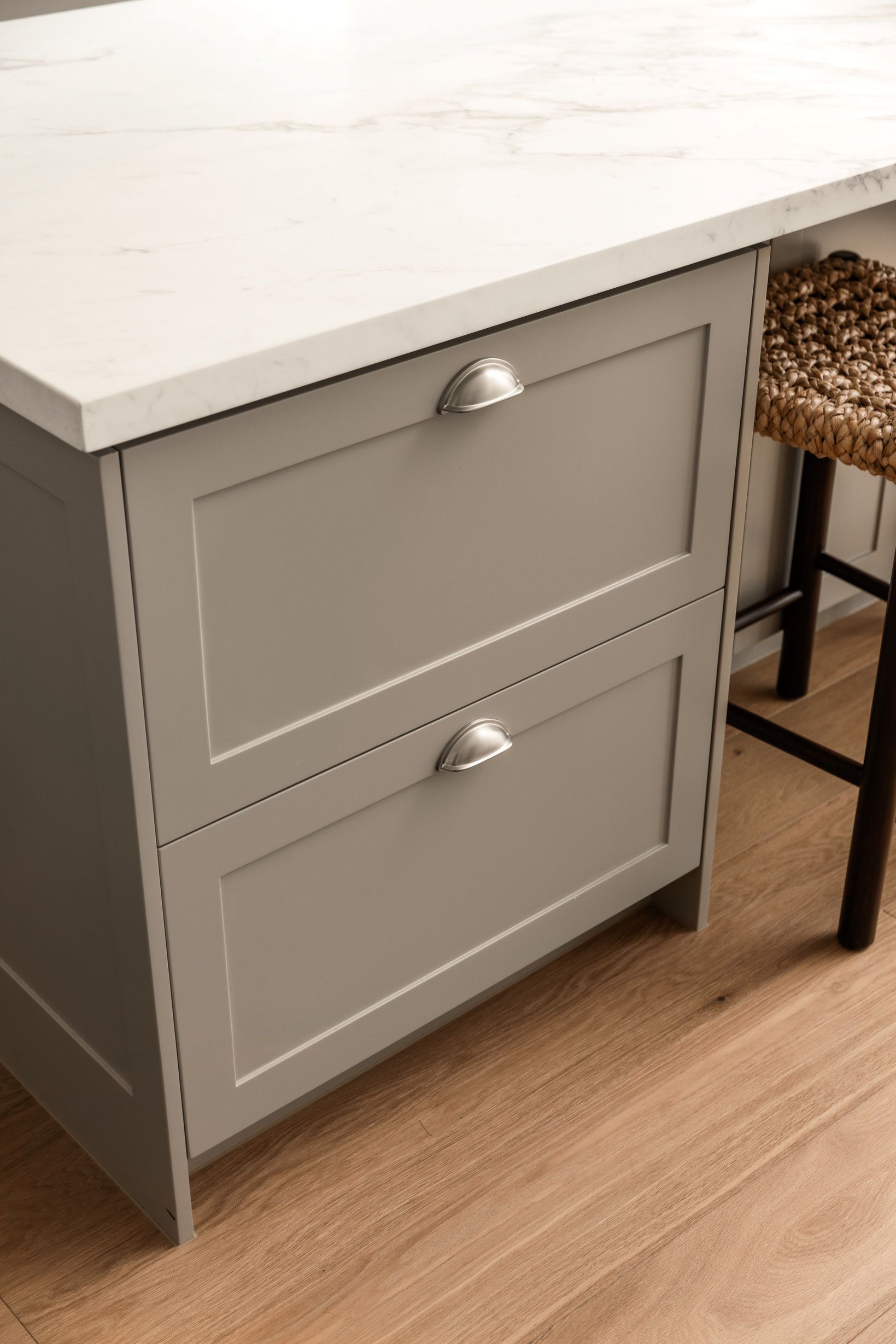 Chesterfield engineered oak plank detail beside grey kitchen cabinetry.