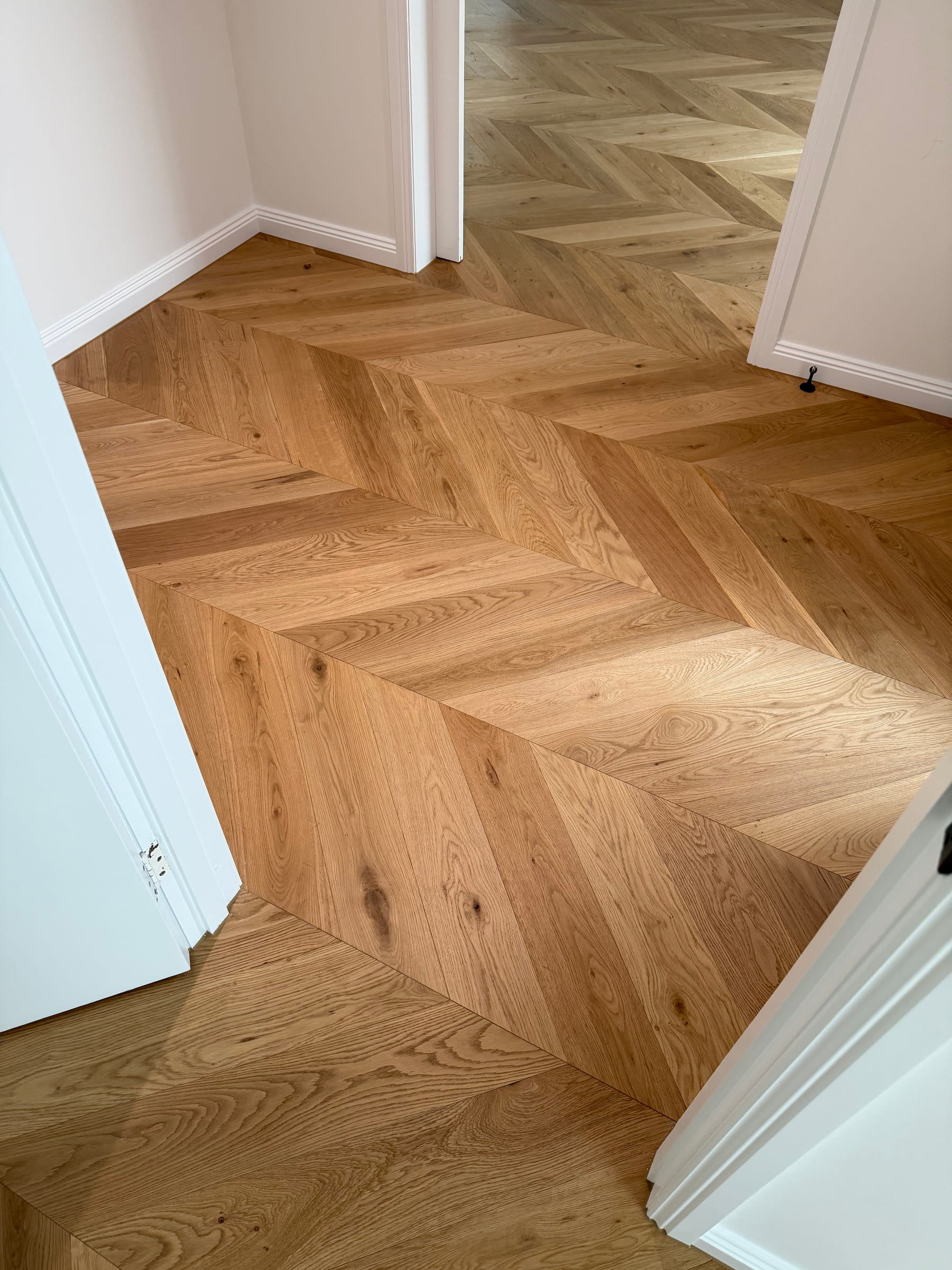Chevron flooring continuing through an internal doorway between rooms in the Bulleen home.
