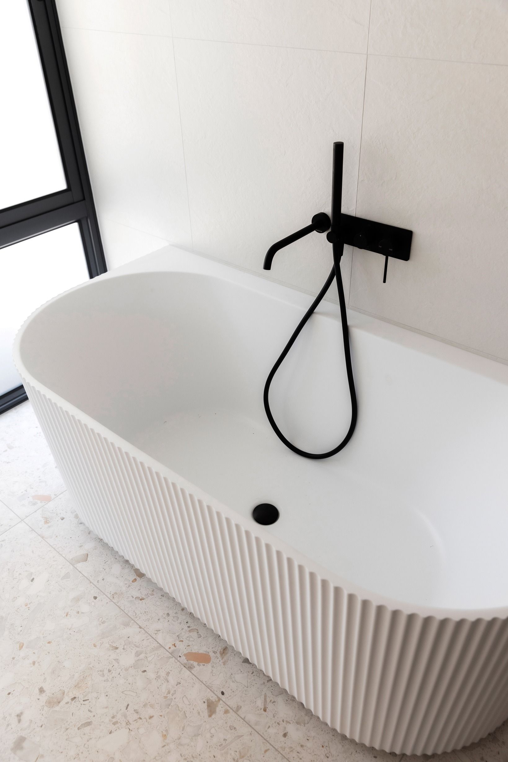 Freestanding bath and black fixtures in the Wheelers Hill residence.