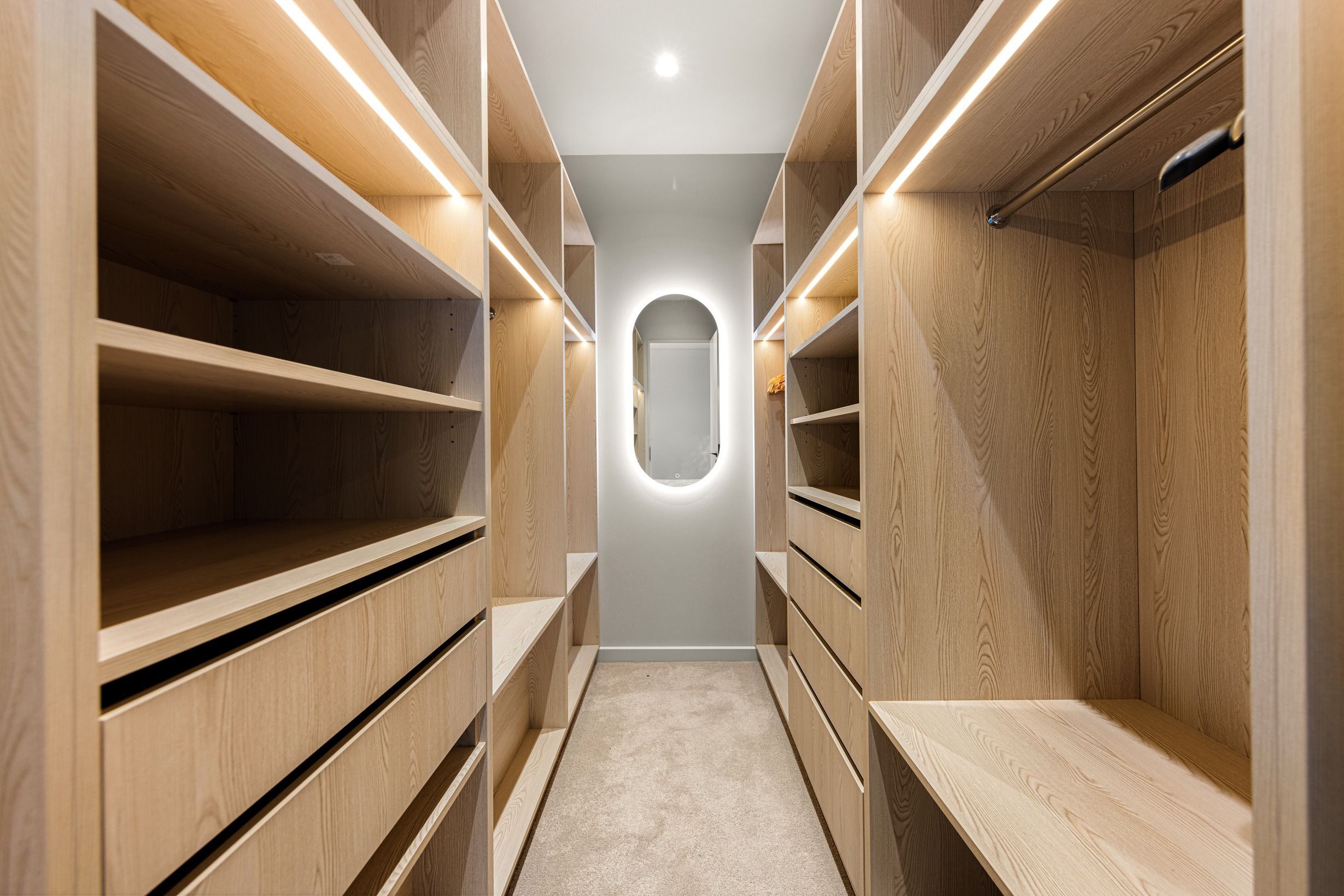 Timber walk-in wardrobe joinery in the completed Wheelers Hill residence.